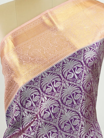 Kanchipuram Silk A rich dark magenta silk saree with peach borders, adorned with delicate silver zari buttas that glisten across the weave. The vibrant contrast exudes grace and tradition. Handwoven in Kanchipuram with 100% pure silk, it's perfect for weddings and festive celebrations. A timeless drape for treasured moments.                  #ManoranjithamSilks #KanjivaramHandloom #PureSilkSaree #BridalElegance #TimelessTradition Kuntalavarali - Magenta Pure Kanjivaram Silk Saree | Zari Buttas - Manoranjith