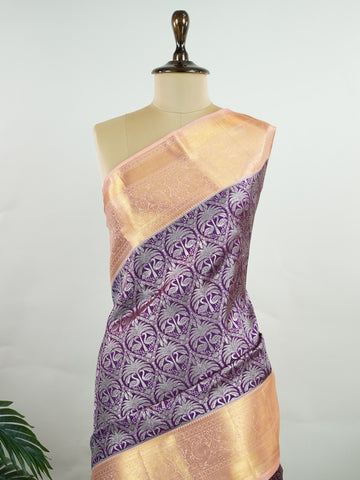 Kanchipuram Silk A rich dark magenta silk saree with peach borders, adorned with delicate silver zari buttas that glisten across the weave. The vibrant contrast exudes grace and tradition. Handwoven in Kanchipuram with 100% pure silk, it's perfect for weddings and festive celebrations. A timeless drape for treasured moments.                  #ManoranjithamSilks #KanjivaramHandloom #PureSilkSaree #BridalElegance #TimelessTradition Kuntalavarali - Magenta Pure Kanjivaram Silk Saree | Zari Buttas - Manoranjith