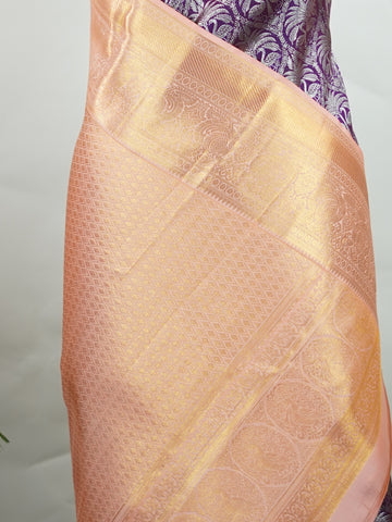 Kanchipuram Silk A rich dark magenta silk saree with peach borders, adorned with delicate silver zari buttas that glisten across the weave. The vibrant contrast exudes grace and tradition. Handwoven in Kanchipuram with 100% pure silk, it's perfect for weddings and festive celebrations. A timeless drape for treasured moments.                  #ManoranjithamSilks #KanjivaramHandloom #PureSilkSaree #BridalElegance #TimelessTradition Kuntalavarali - Magenta Pure Kanjivaram Silk Saree | Zari Buttas - Manoranjith