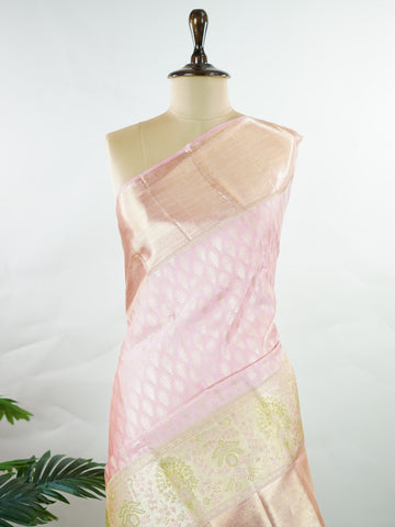 Kanchipuram Silk A delicate baby pink silk saree with matching baby pink borders, adorned with gold and silver zari buttas that shimmer softly. The monochrome palette exudes subtle elegance and grace. Handwoven in Kanchipuram with 100% pure silk, it's perfect for weddings and special celebrations. A timeless drape for moments to cherish.                #ManoranjithamSilks #KanjivaramHandloom #PureSilkSaree #BridalElegance #TimelessTradition Hindolam - Pink Pure Kanjivaram Silk Saree | Zari Buttas - Manoranj