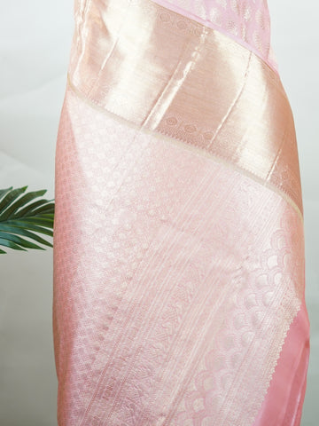 Kanchipuram Silk A delicate baby pink silk saree with matching baby pink borders, adorned with gold and silver zari buttas that shimmer softly. The monochrome palette exudes subtle elegance and grace. Handwoven in Kanchipuram with 100% pure silk, it's perfect for weddings and special celebrations. A timeless drape for moments to cherish.                #ManoranjithamSilks #KanjivaramHandloom #PureSilkSaree #BridalElegance #TimelessTradition Hindolam - Pink Pure Kanjivaram Silk Saree | Zari Buttas - Manoranj