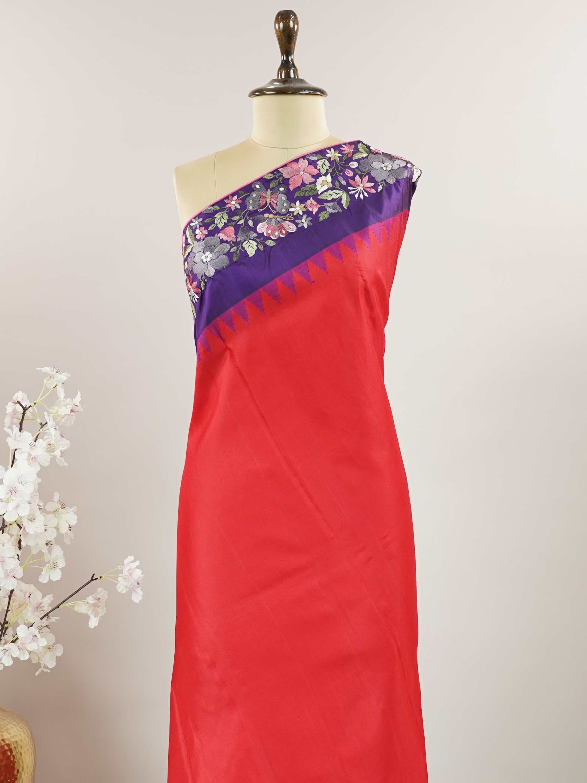 Gadwal Silk Bright red silk with deep blue borders, graced by fine embroidery. Striking contrast for weddings and special events. The soft silk moves effortlessly with every step. A saree that blends drama with tradition. #RedBlueSaree #GadwalSilk #NoZari #HeritageWeaves Hamsanandi - Bright Red Handwork Embroidered Silk Saree | Parsigara Embroidery - Manoranjitham Weaves - Handloom Store