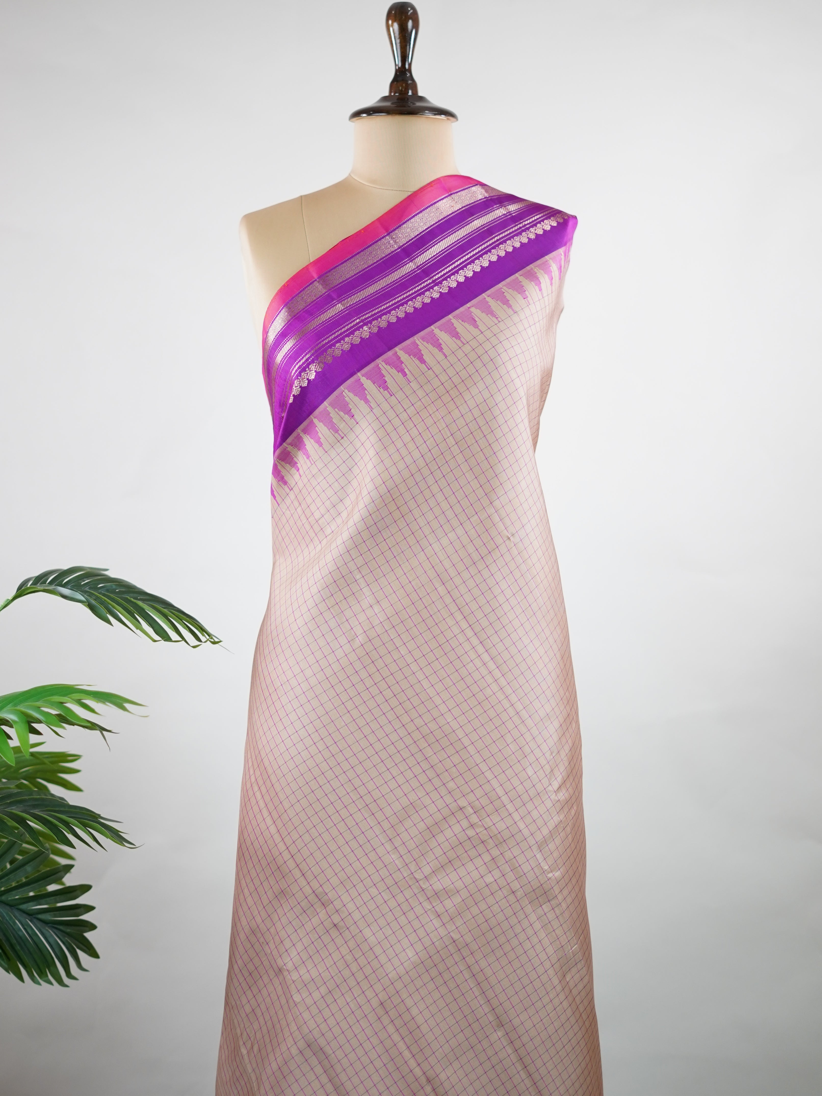 Gadwal Silk This elegant Gadwal saree features a beige body paired with a magenta pink border, crafted from 100% pure silk.br
The body is adorned with subtle stripes, adding a refined texture and charm.br
Finished with a delicate zari and thread border, it showcases the timeless handloom artistry of Gadwal weaving. Maheshwari - Beige Handloom Gadwal Silk Saree | Pure Silk | Zari Border - Manoranjitham Weaves - Handloom Store