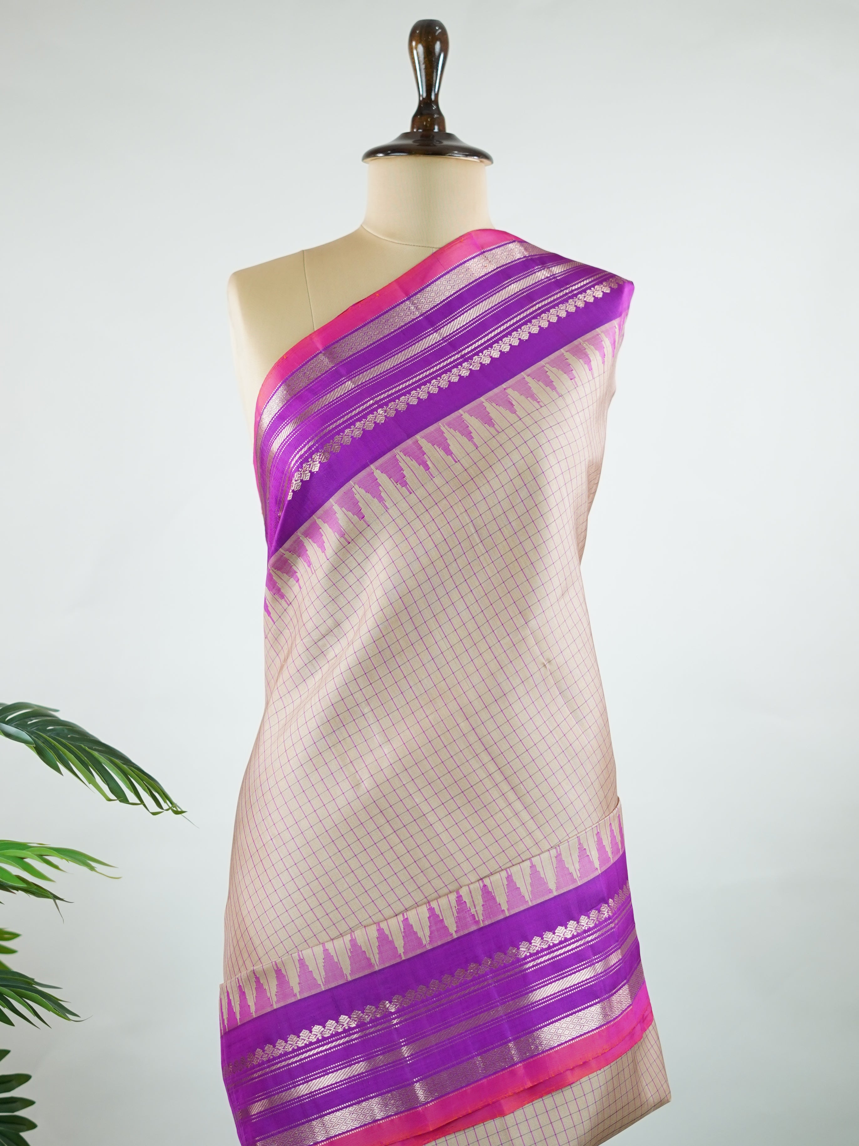 Gadwal Silk This elegant Gadwal saree features a beige body paired with a magenta pink border, crafted from 100% pure silk.br
The body is adorned with subtle stripes, adding a refined texture and charm.br
Finished with a delicate zari and thread border, it showcases the timeless handloom artistry of Gadwal weaving. Maheshwari - Beige Handloom Gadwal Silk Saree | Pure Silk | Zari Border - Manoranjitham Weaves - Handloom Store