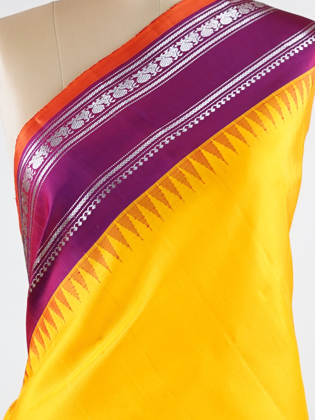 Gadwal Silk This vibrant Gadwal saree features a yellow body paired with a magenta pink border, crafted from 100% pure silk.br
The body is adorned with delicate resham checks, adding texture and understated elegance.br
Finished with a graceful gap border, it beautifully showcases the timeless handloom artistry of Gadwal weaving. Shankari - Yellow Handloom Gadwal Silk Saree | Pure Silk | Zari Border - Manoranjitham Weaves - Handloom Store