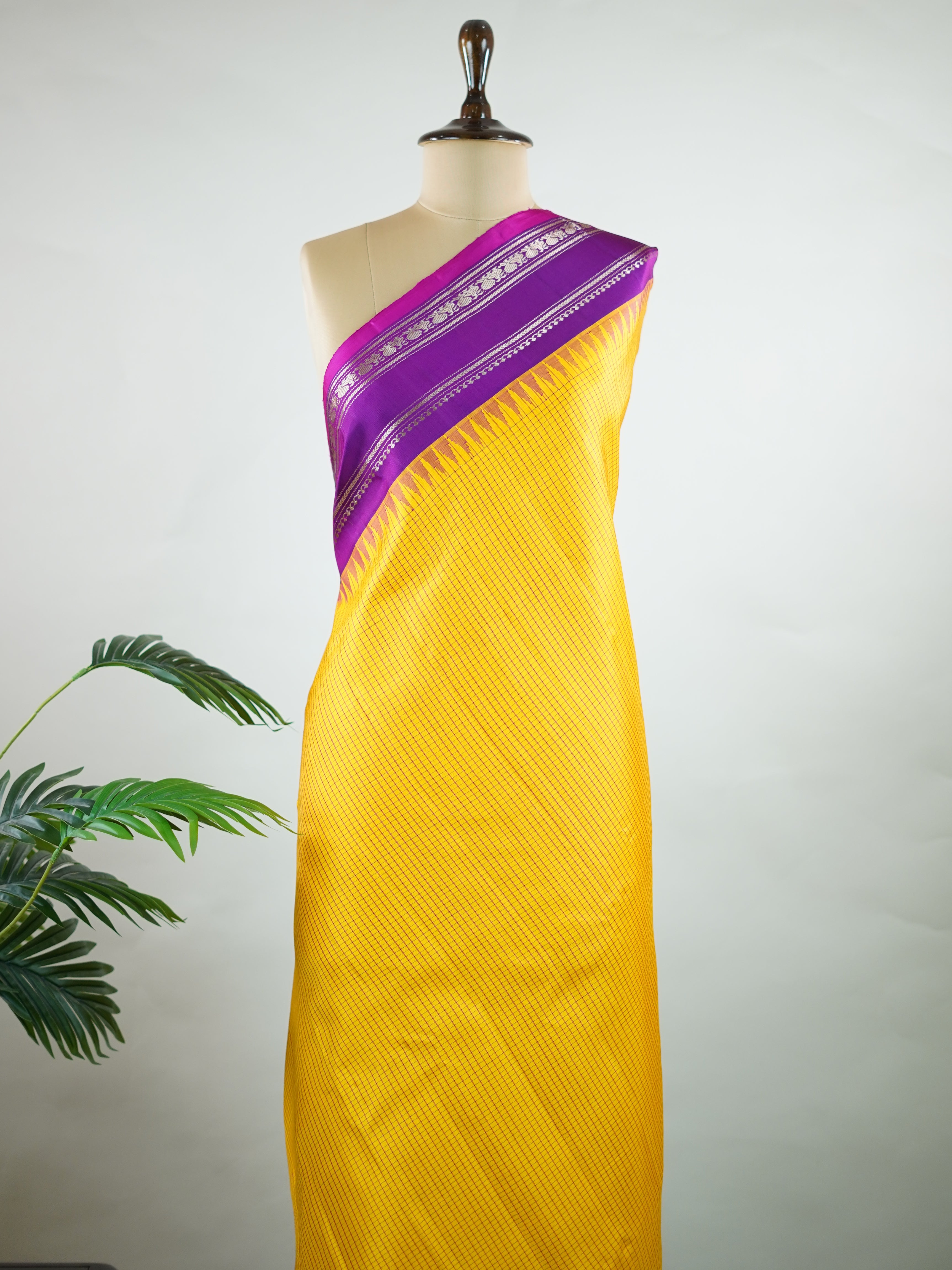 Gadwal Silk This elegant Gadwal saree features a yellow body paired with a magenta pink border, crafted from 100% pure silk.br
The plain body offers a clean, sophisticated look, perfect for any occasion.br
Finished with a graceful gap border, it highlights the timeless handloom craftsmanship of Gadwal weaving. Sreekari - Yellow Handloom Gadwal Silk Saree | Pure Silk | Zari Border - Manoranjitham Weaves - Handloom Store