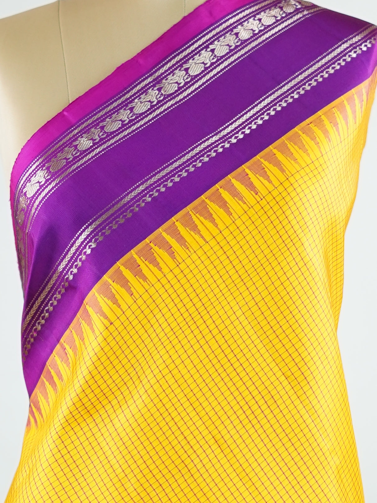 Gadwal Silk This elegant Gadwal saree features a yellow body paired with a magenta pink border, crafted from 100% pure silk.br
The plain body offers a clean, sophisticated look, perfect for any occasion.br
Finished with a graceful gap border, it highlights the timeless handloom craftsmanship of Gadwal weaving. Sreekari - Yellow Handloom Gadwal Silk Saree | Pure Silk | Zari Border - Manoranjitham Weaves - Handloom Store