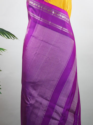 Gadwal Silk This elegant Gadwal saree features a yellow body paired with a magenta pink border, crafted from 100% pure silk.br
The plain body offers a clean, sophisticated look, perfect for any occasion.br
Finished with a graceful gap border, it highlights the timeless handloom craftsmanship of Gadwal weaving. Sreekari - Yellow Handloom Gadwal Silk Saree | Pure Silk | Zari Border - Manoranjitham Weaves - Handloom Store