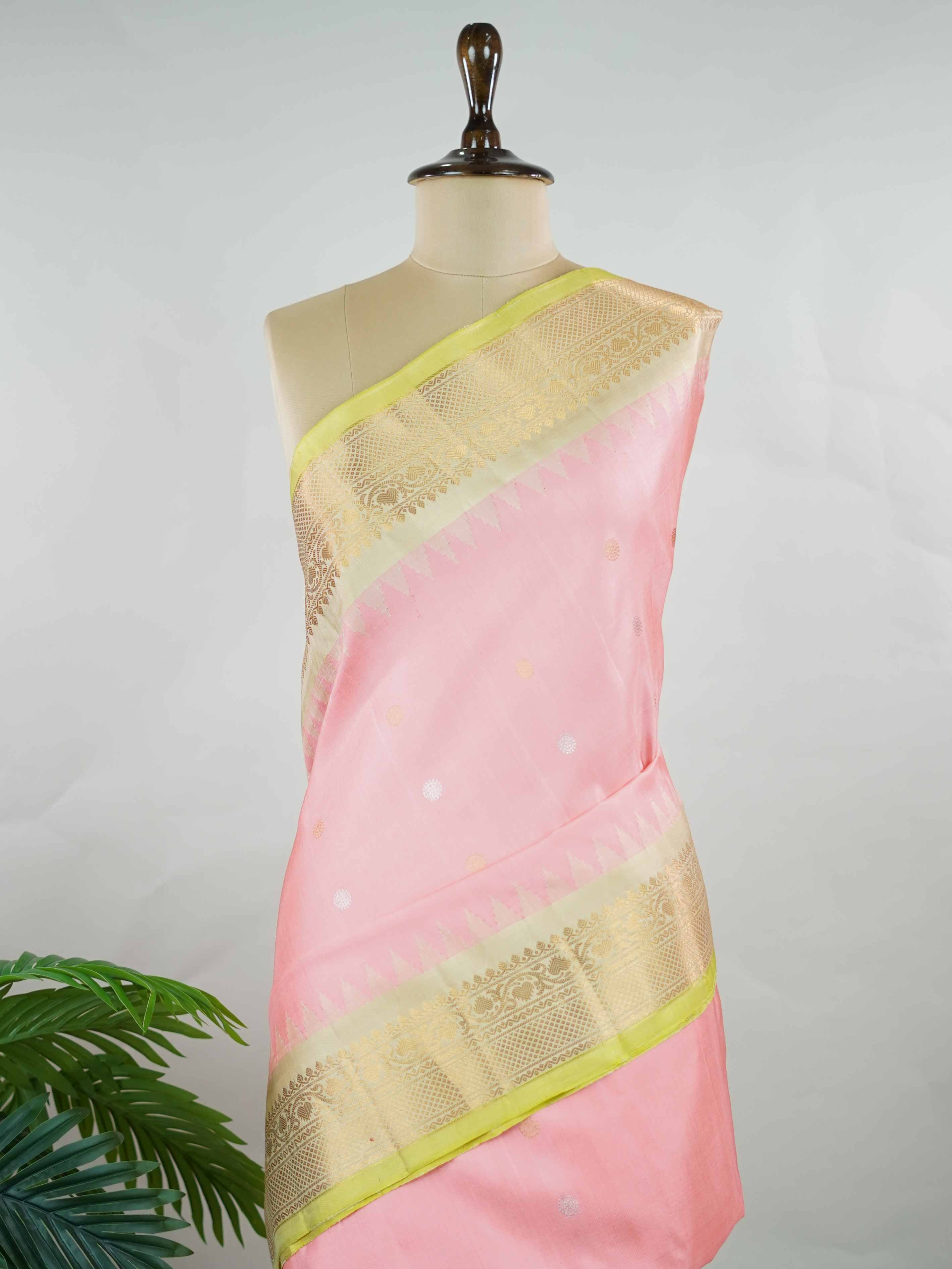 Gadwal Silk Embrace soft elegance with this Gadwal saree in a delicate baby pink shade, paired with a graceful beige blouse. /spanspanThe design is enriched with elegant gold and silver buttas that add a subtle festive glow. /spanspanIts traditional weave offers a refined drape that beautifully blends charm and sophistication. /spanspanPerfect for festive occasions, celebrations, and special gatherings that call for timeless grace. Shashwati - Handloom Gadwal Silk Saree | Pure Silk | Zari Border - Manoranji