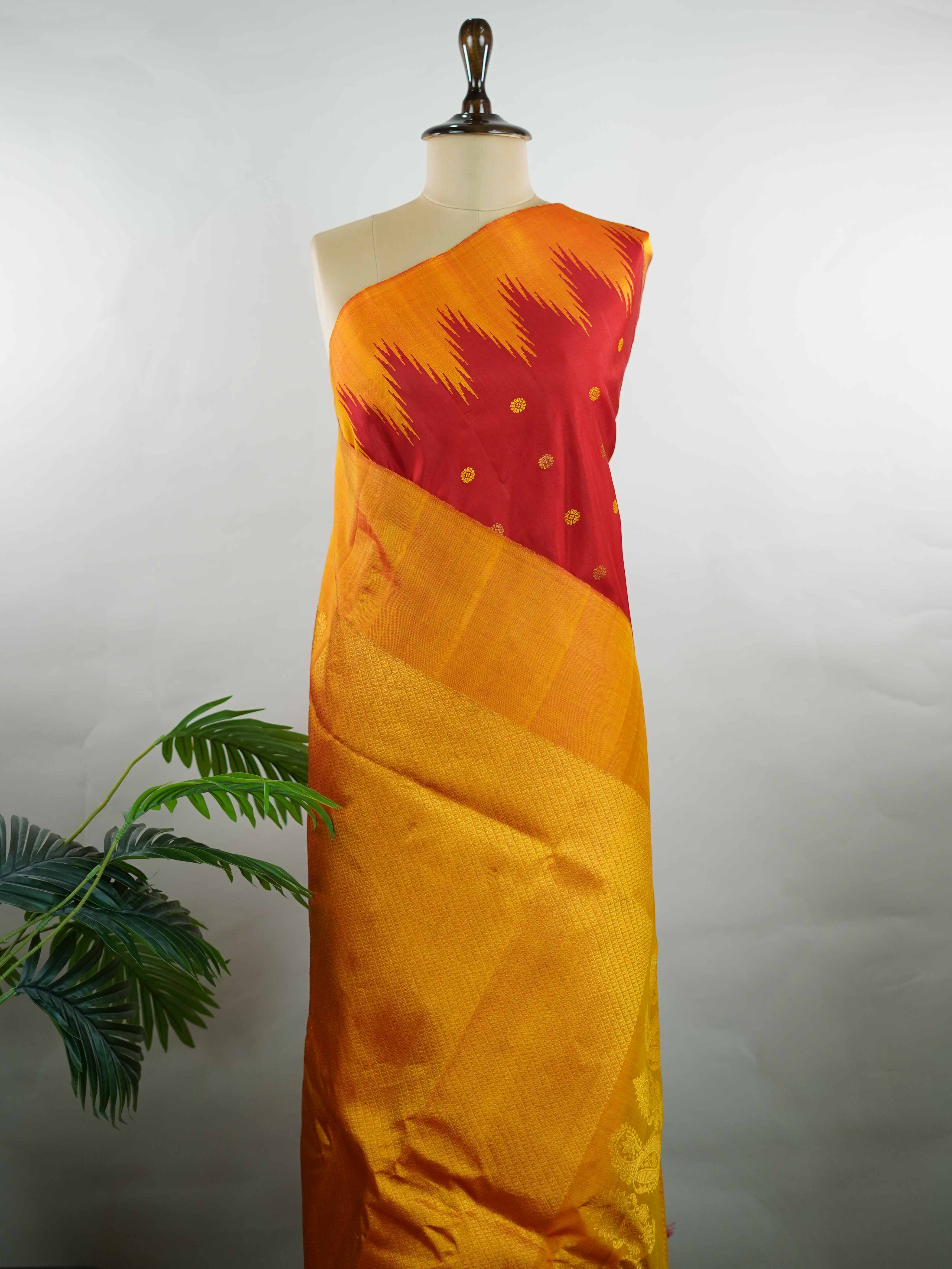 Gadwal Silk This vibrant Gadwal saree features a red body paired with a mustard border, crafted from 100% pure silk.br
The body is adorned with delicate thread buttis, while the border showcases traditional temple kota kommas for a classic touch.br
Completed with a contrasting blouse, it highlights exquisite handloom craftsmanship and timeless elegance. Ekanta - Red Handloom Gadwal Silk Saree | Pure Silk | Zari Border - Manoranjitham Weaves - Handloom Store