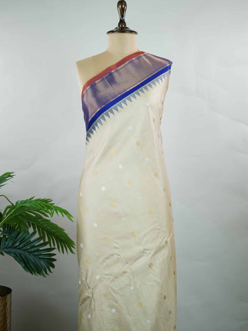 Gadwal Silk Elevate your ethnic elegance with this Gadwal saree in a graceful beige shade, paired with a royal blue blouse. The saree is beautifully adorned with gold and silver buttas that add a subtle festive shimmer. Its traditional weave ensures a rich drape that blends sophistication with cultural charm. Perfect for weddings, festive occasions, and celebrations that call for timeless beauty. Shivaatmika - Handloom Gadwal Silk Saree | Pure Silk | Zari Border - Manoranjitham Weaves - Handloom Store