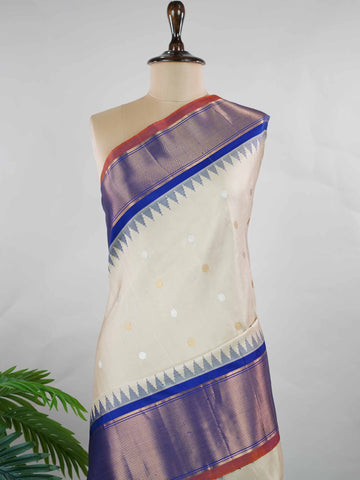 Gadwal Silk Elevate your ethnic elegance with this Gadwal saree in a graceful beige shade, paired with a royal blue blouse. The saree is beautifully adorned with gold and silver buttas that add a subtle festive shimmer. Its traditional weave ensures a rich drape that blends sophistication with cultural charm. Perfect for weddings, festive occasions, and celebrations that call for timeless beauty. Shivaatmika - Handloom Gadwal Silk Saree | Pure Silk | Zari Border - Manoranjitham Weaves - Handloom Store