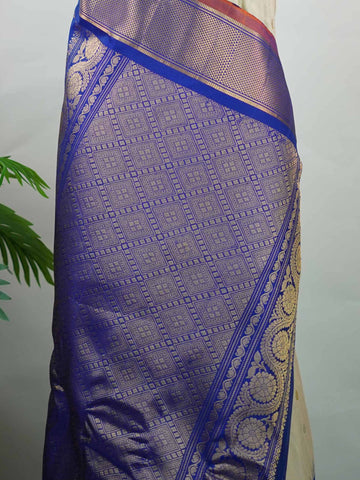 Gadwal Silk Elevate your ethnic elegance with this Gadwal saree in a graceful beige shade, paired with a royal blue blouse. The saree is beautifully adorned with gold and silver buttas that add a subtle festive shimmer. Its traditional weave ensures a rich drape that blends sophistication with cultural charm. Perfect for weddings, festive occasions, and celebrations that call for timeless beauty. Shivaatmika - Handloom Gadwal Silk Saree | Pure Silk | Zari Border - Manoranjitham Weaves - Handloom Store
