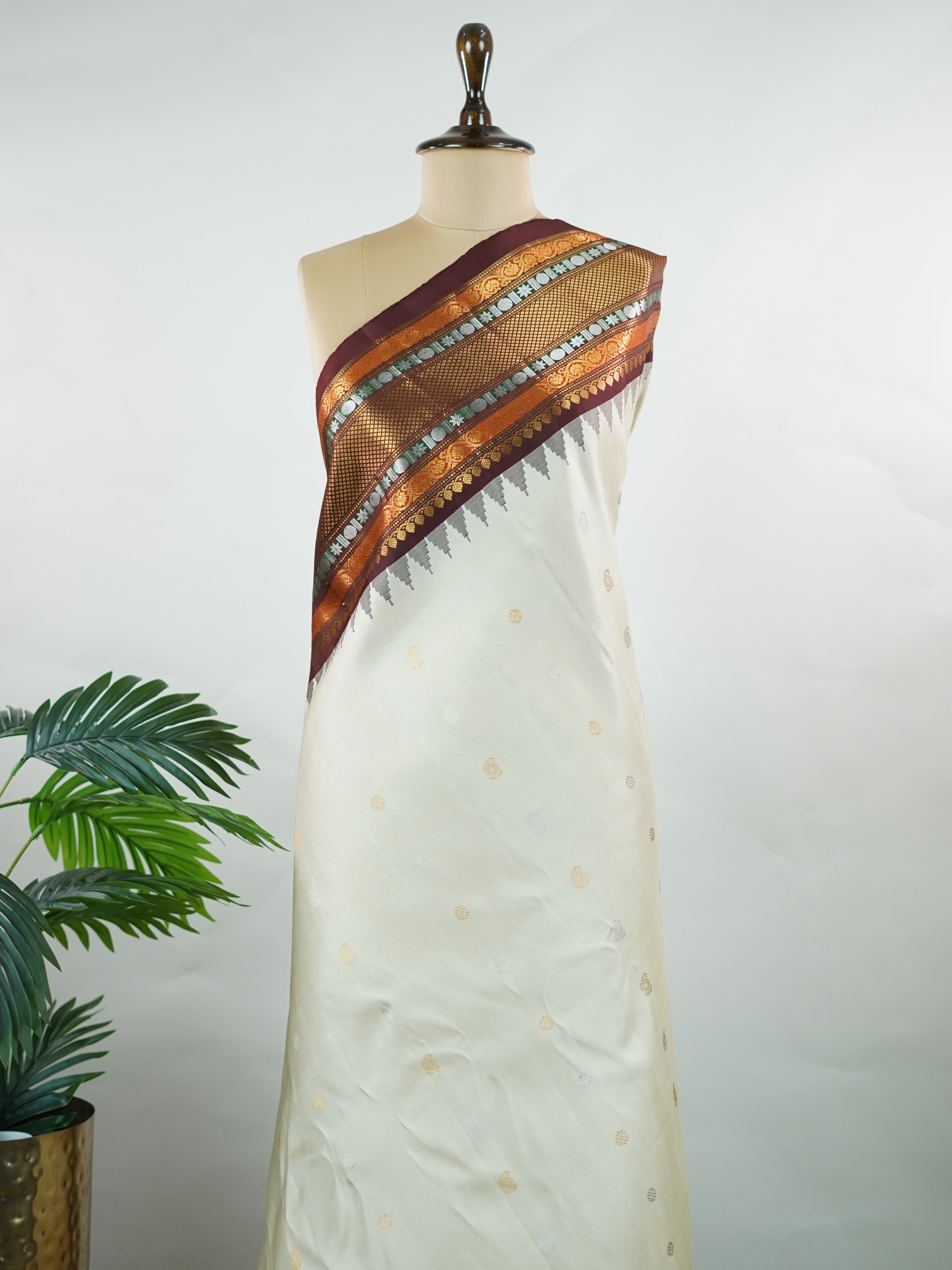 Gadwal Silk This elegant Gadwal saree features a beige body paired with a rich brown border, crafted from 100% pure silk.br
The body is adorned with subtle zari buttis, adding delicate shimmer and charm.br
Finished with a bold, wide border, it showcases the classic handloom artistry of Gadwal weaving. Parvathipriya - Gadwal  saree - Manoranjitham Weaves - Handloom Store