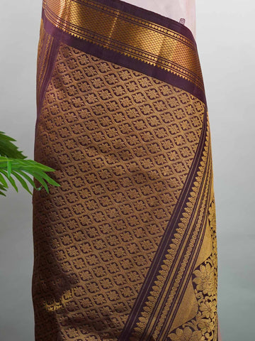 Gadwal Silk Make a graceful statement with this Gadwal saree in a rich peach shade, paired with a deep brown blouse. The design is enhanced with elegant gold and silk buttas, reflecting traditional craftsmanship and subtle luxury. Its classic weave ensures a refined drape that beautifully blends comfort with sophistication. Perfect for festive occasions, cultural events, and celebrations that call for timeless ethnic elegance. Indumati - Handloom Gadwal Silk Saree | Pure Silk | Zari Border - Manoranjitham W