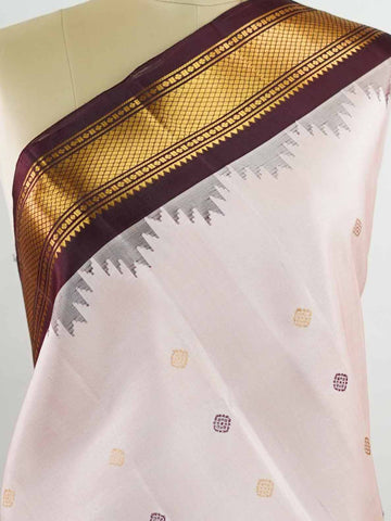 Gadwal Silk Make a graceful statement with this Gadwal saree in a rich peach shade, paired with a deep brown blouse. The design is enhanced with elegant gold and silk buttas, reflecting traditional craftsmanship and subtle luxury. Its classic weave ensures a refined drape that beautifully blends comfort with sophistication. Perfect for festive occasions, cultural events, and celebrations that call for timeless ethnic elegance. Indumati - Handloom Gadwal Silk Saree | Pure Silk | Zari Border - Manoranjitham W