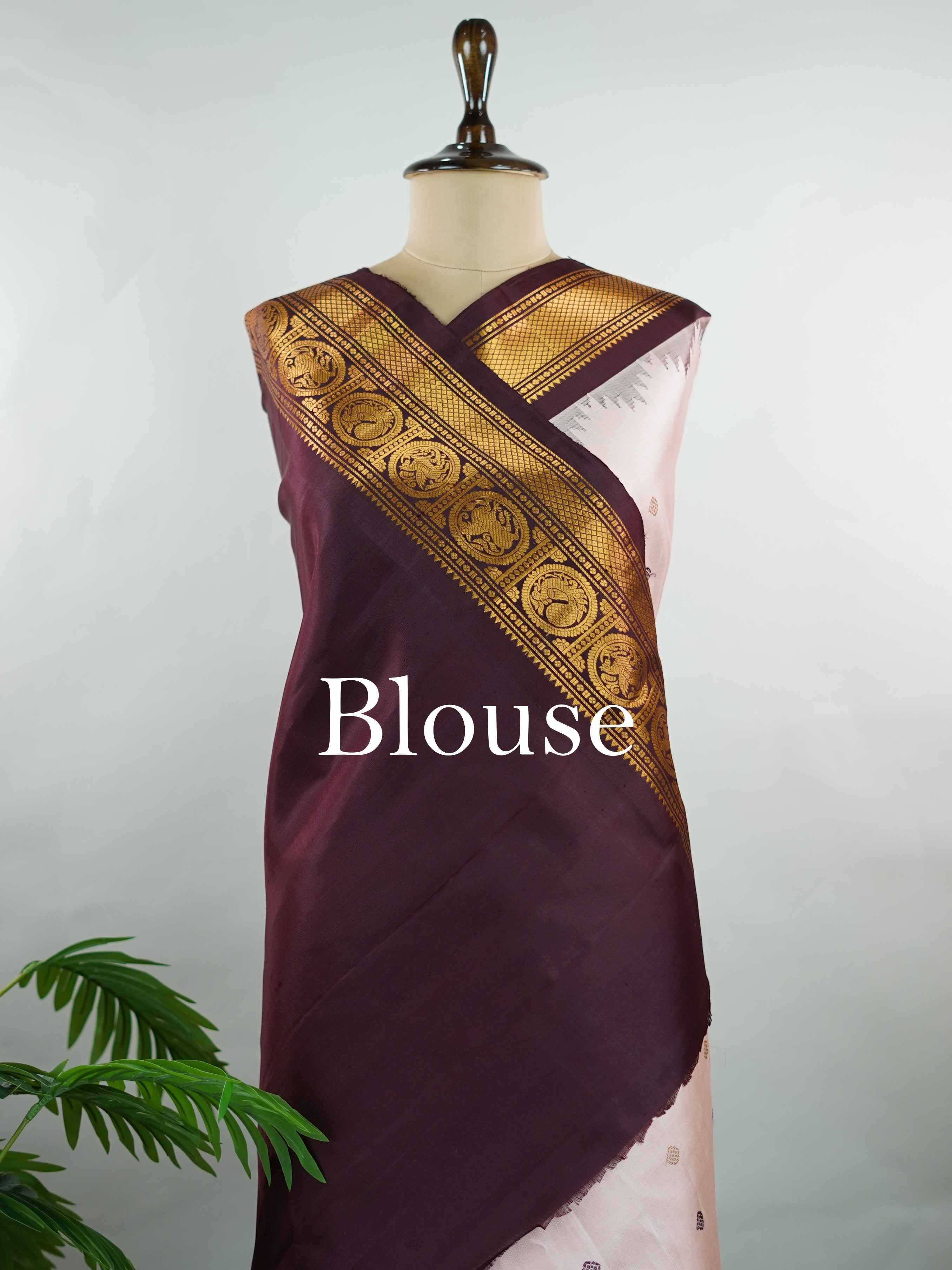 Gadwal Silk Make a graceful statement with this Gadwal saree in a rich peach shade, paired with a deep brown blouse. The design is enhanced with elegant gold and silk buttas, reflecting traditional craftsmanship and subtle luxury. Its classic weave ensures a refined drape that beautifully blends comfort with sophistication. Perfect for festive occasions, cultural events, and celebrations that call for timeless ethnic elegance. Indumati - Handloom Gadwal Silk Saree | Pure Silk | Zari Border - Manoranjitham W