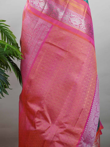 Gadwal Silk Stand out in elegance with this Gadwal saree in a rich peacock blue shade, paired beautifully with a contrasting pink blouse. The weave is adorned with silver and gold Chakram and Annapakshi buttas, showcasing exquisite traditional artistry. The fine detailing adds a regal charm, making it a perfect blend of heritage and sophistication.  Satyavati - Handloom Gadwal Silk Saree | Pure Silk | Zari Border - Manoranjitham Weaves - Handloom Store