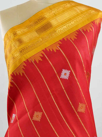 Gadwal Silk Make a striking statement with this elegant Gadwal saree in a vibrant red shade, paired beautifully with a contrasting yellow blouse. The design is adorned with intricate silver and gold kolam buttas, reflecting traditional artistry and cultural richness. The classic weave enhances its graceful drape, giving it a timeless and festive appeal. Perfect for weddings, festive celebrations, and auspicious occasions that call for a regal traditional look. Vinata - Handloom Gadwal Silk Saree | Pure Silk