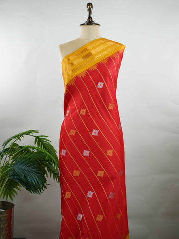 Gadwal Silk Make a striking statement with this elegant Gadwal saree in a vibrant red shade, paired beautifully with a contrasting yellow blouse. The design is adorned with intricate silver and gold kolam buttas, reflecting traditional artistry and cultural richness. The classic weave enhances its graceful drape, giving it a timeless and festive appeal. Perfect for weddings, festive celebrations, and auspicious occasions that call for a regal traditional look. Vinata - Handloom Gadwal Silk Saree | Pure Silk