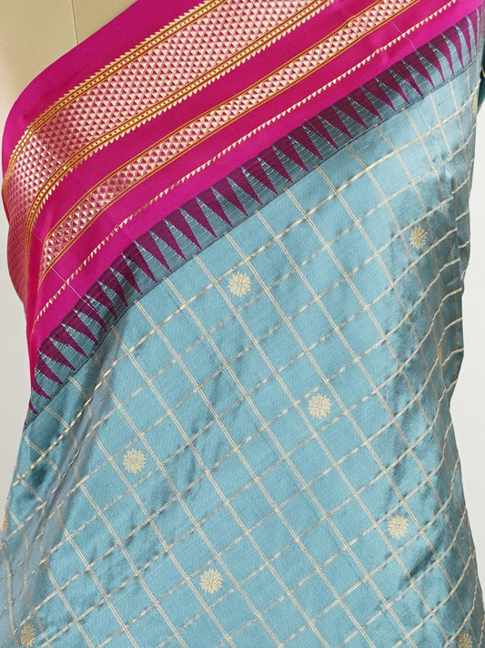Narayanpet Narayanpet sarees with checks and buttis showcase a perfect blend of tradition and simplicity, featuring intricate motifs woven over classic check patterns.
Their vibrant colors and fine craftsmanship make them elegant choices for any occasion.
 Chamundi - Manoranjitham Weaves - Handloom Store