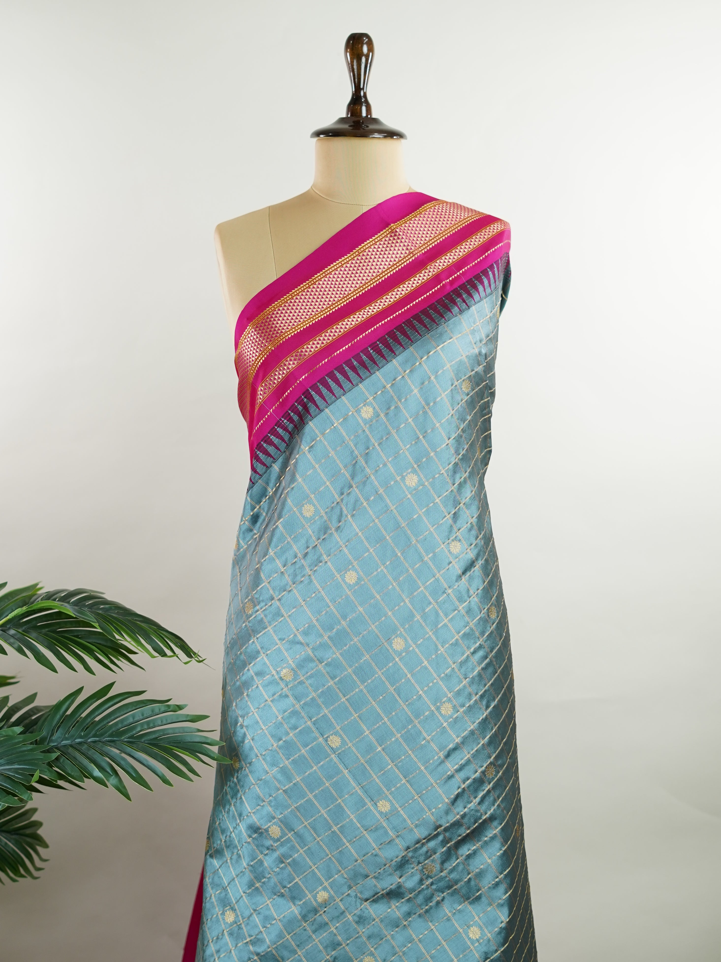 Narayanpet Narayanpet sarees with checks and buttis showcase a perfect blend of tradition and simplicity, featuring intricate motifs woven over classic check patterns.
Their vibrant colors and fine craftsmanship make them elegant choices for any occasion.
 Chamundi - Manoranjitham Weaves - Handloom Store