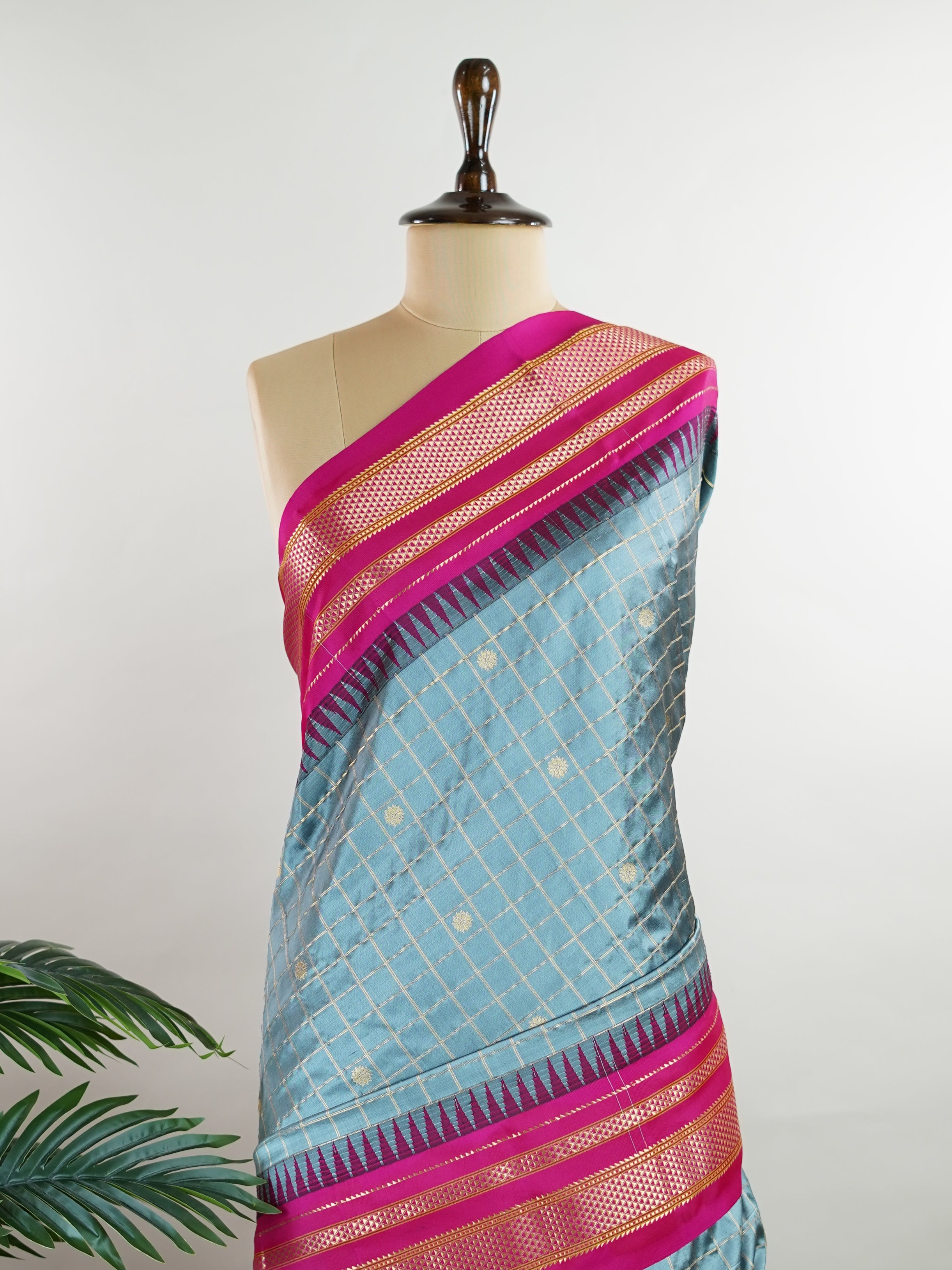 Narayanpet Narayanpet sarees with checks and buttis showcase a perfect blend of tradition and simplicity, featuring intricate motifs woven over classic check patterns.
Their vibrant colors and fine craftsmanship make them elegant choices for any occasion.
 Chamundi - Manoranjitham Weaves - Handloom Store