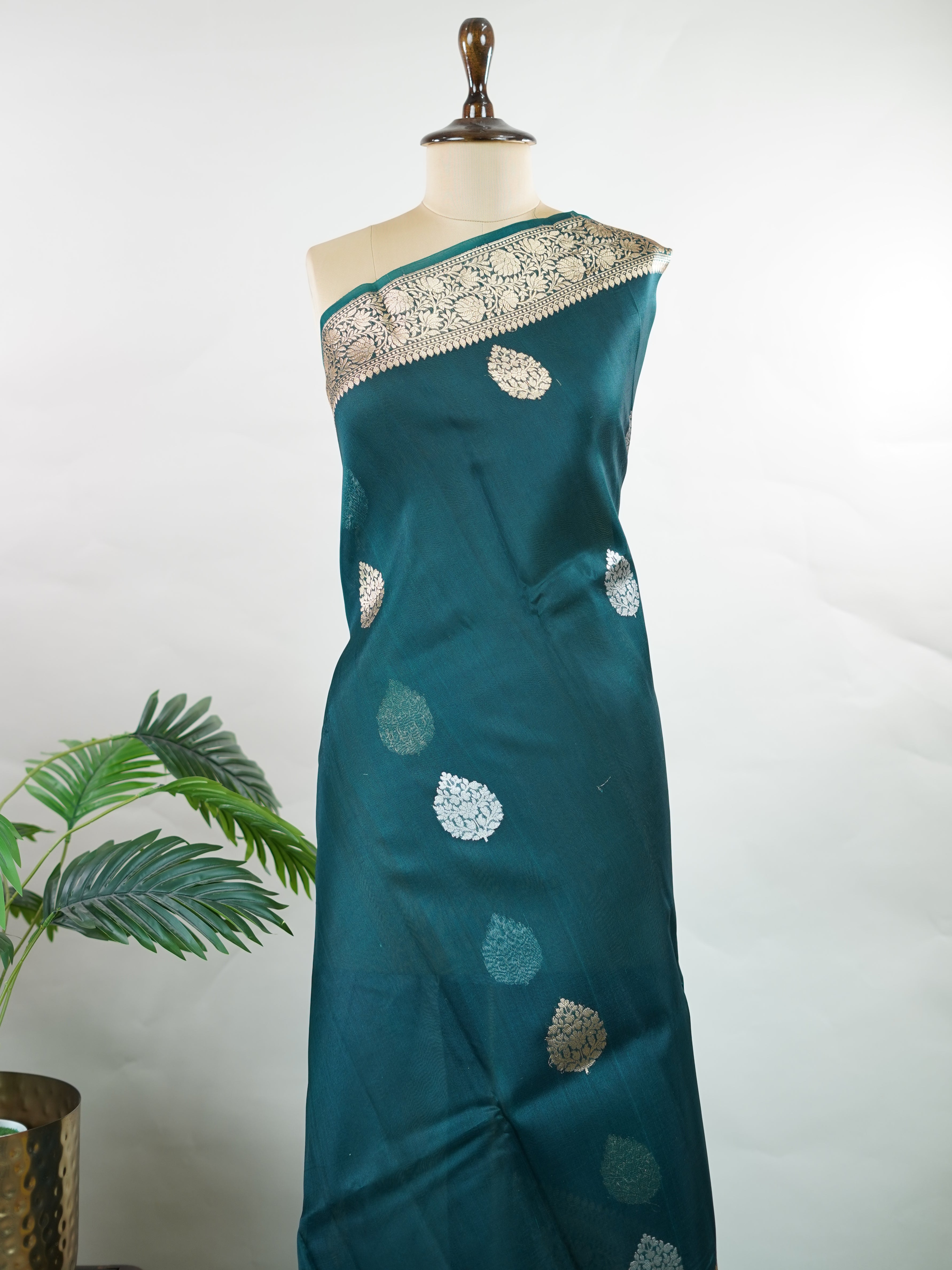 Katan This kora saree features delicate woven buttis and offers a light, comfortable drape. Saranga - Banarasi Kora Saree | Woven Buttas - Manoranjitham Weaves - Handloom Store