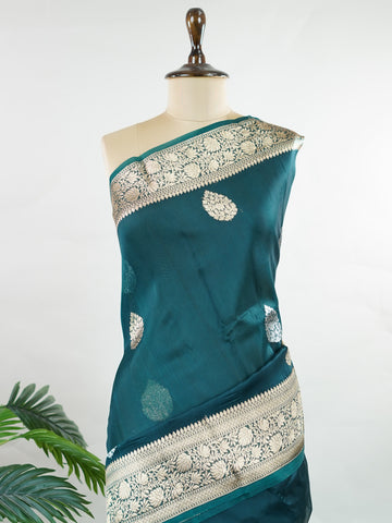 Katan This kora saree features delicate woven buttis and offers a light, comfortable drape. Saranga - Banarasi Kora Saree | Woven Buttas - Manoranjitham Weaves - Handloom Store