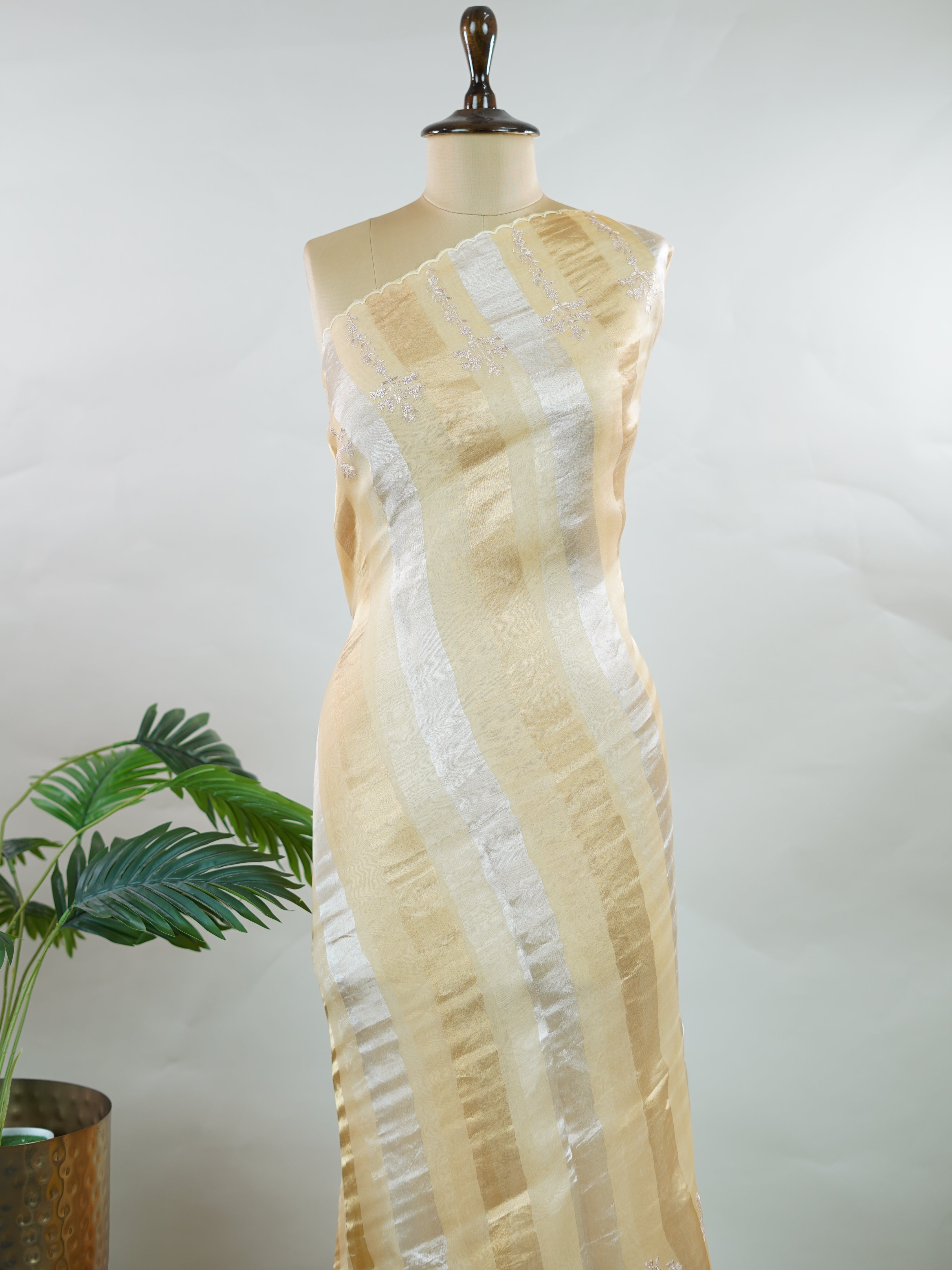 Organza Elegant organza saree in gold and cream hues featuring exquisite Aari Peeta work on the pallu. The sheer, lightweight fabric drapes gracefully, creating a regal and refined silhouette.br data-start=186 data-end=189Intricate handcrafted embroidery adds richness, texture, and timeless traditional charm.br data-start=277 data-end=280Perfect for weddings, festive celebrations, and special occasions with classic elegance. Dhanya - Organza Saree | Embroidered - Manoranjitham Weaves - Handloom Store