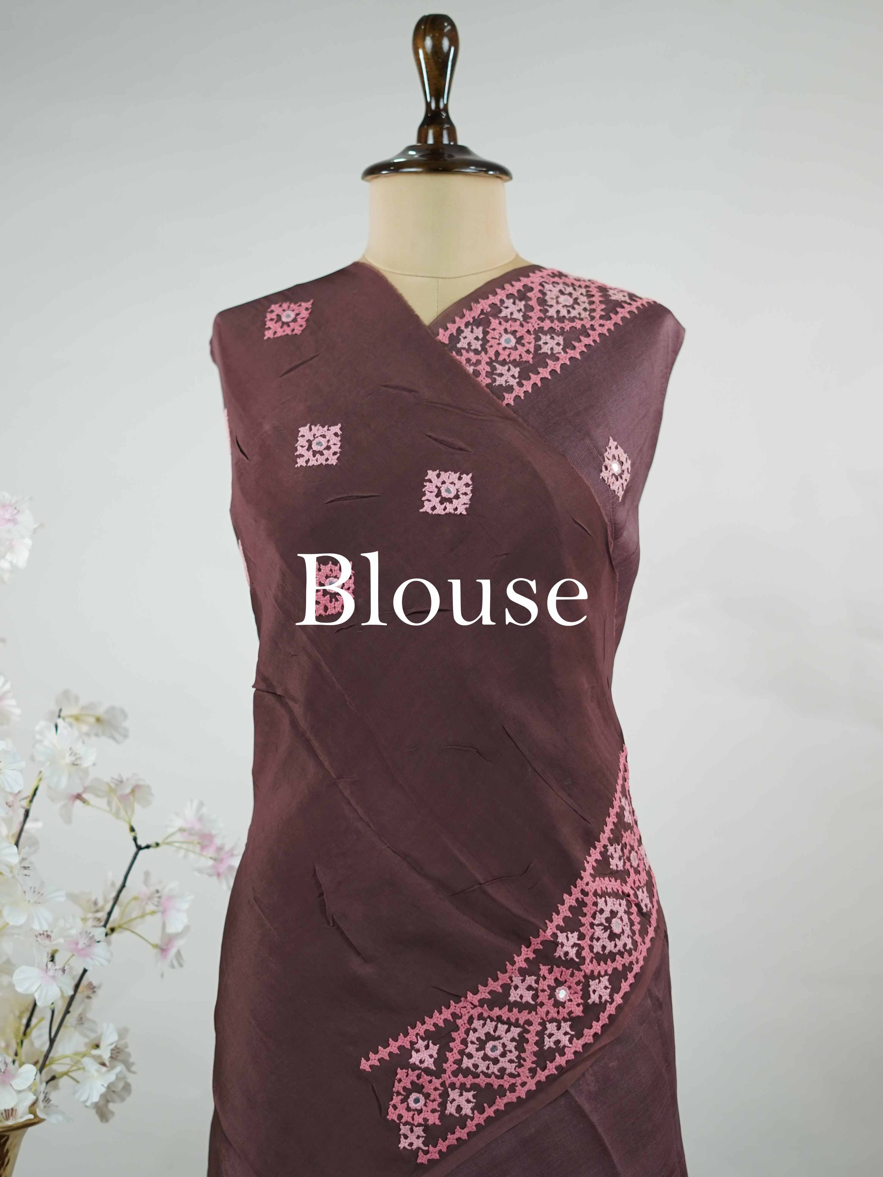 Katan A warm brown Kora saree highlighted with soft pink accents, creating a graceful contrast.br
Enhanced with vibrant Kutch embroidery, it showcases rich artisanal detail with a refined, contemporary appeal. Kadhambari - Warm Brown Kora Silk Saree | Kutch Work - Manoranjitham Weaves - Handloom Store