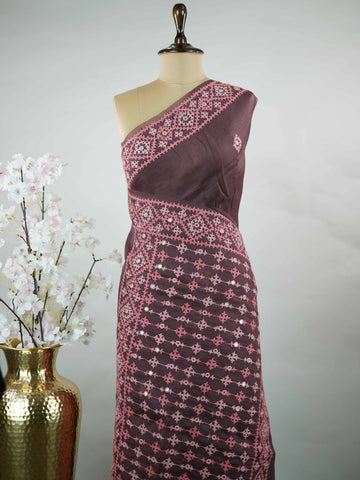 Katan A warm brown Kora saree highlighted with soft pink accents, creating a graceful contrast.br
Enhanced with vibrant Kutch embroidery, it showcases rich artisanal detail with a refined, contemporary appeal. Kadhambari - Warm Brown Kora Silk Saree | Kutch Work - Manoranjitham Weaves - Handloom Store