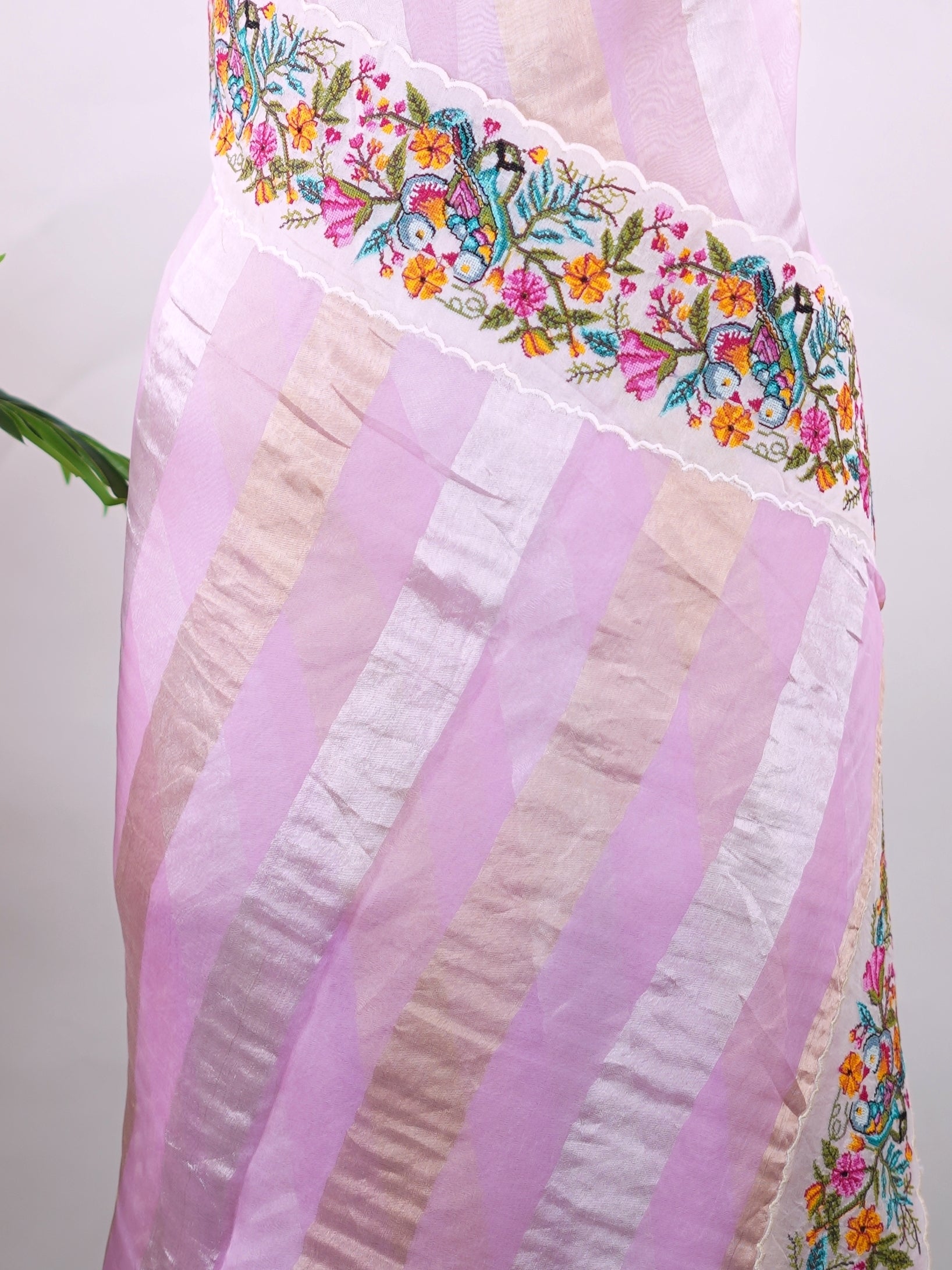 Organza Elegant organza saree in pink and white tones featuring intricate pitted point work on the pallu. The lightweight, sheer fabric drapes beautifully, giving a soft and feminine silhouette.br data-start=186 data-end=189Delicate handcrafted embroidery adds richness, detail, and timeless ethnic charm.br data-start=270 data-end=273Perfect for weddings, festive occasions, and special celebrations with graceful elegance. Rishmika - Organza Saree | Embroidered - Manoranjitham Weaves - Handloom Store