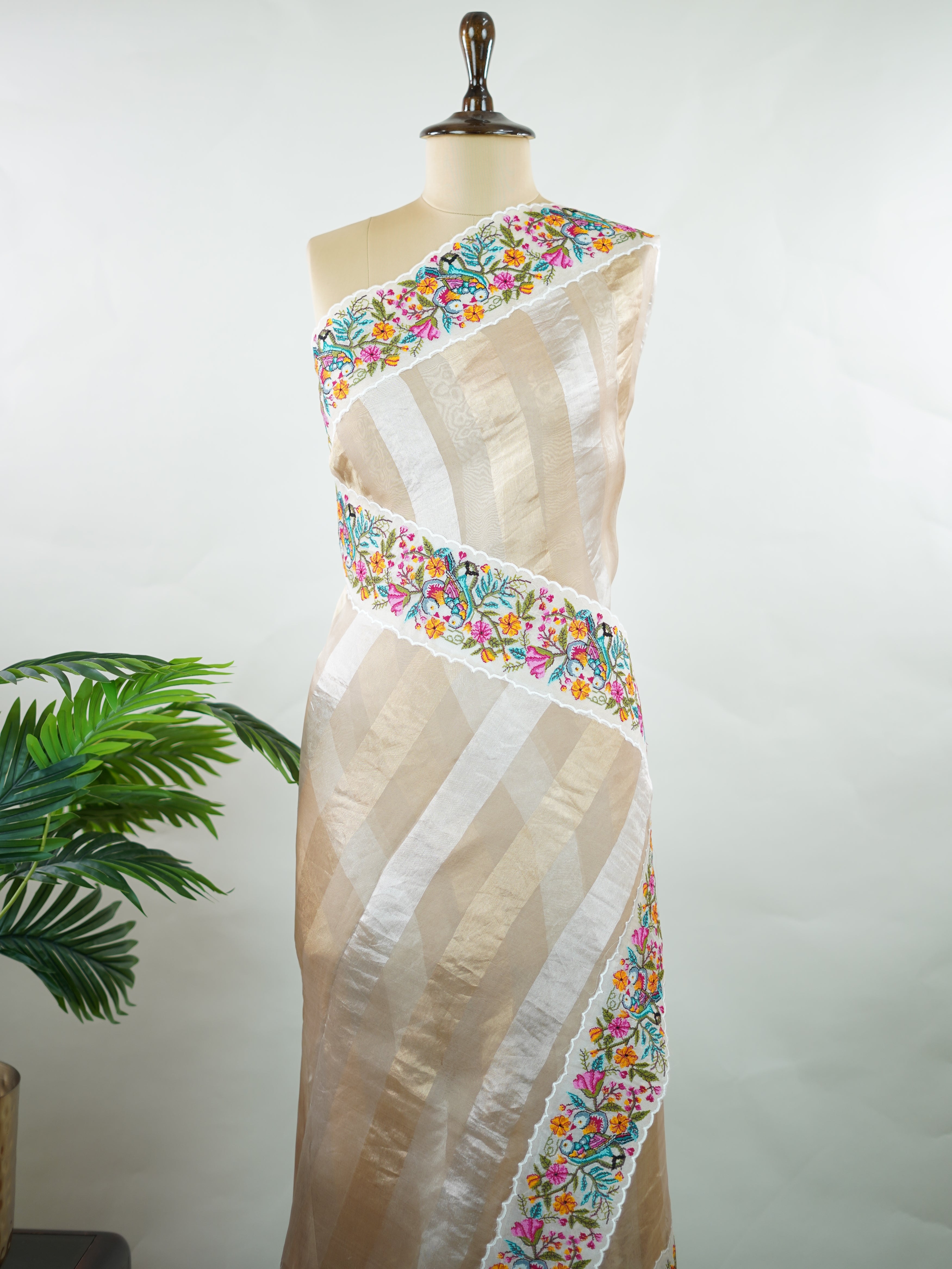 Organza Elegant organza saree in cream and white hues featuring exquisite pitted point work on the pallu. The sheer, lightweight fabric drapes gracefully, creating a soft and refined silhouette.br data-start=186 data-end=189Intricate handcrafted embroidery adds subtle richness, texture, and timeless charm.br data-start=272 data-end=275Perfect for weddings, festive occasions, and special celebrations with classic elegance. Shreenika - Organza Saree | Embroidered - Manoranjitham Weaves - Handloom Store
