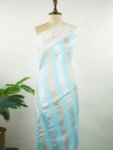Organza Elegant organza saree in sky blue and white tones featuring intricate Aari Peeta work on the pallu. The sheer, lightweight fabric drapes beautifully, giving a fresh and graceful silhouette.br data-start=191 data-end=194Delicate handcrafted embroidery adds depth, charm, and timeless sophistication.br data-start=273 data-end=276Perfect for weddings, festive celebrations, and special occasions with serene ethnic elegance. Rhea - Organza Saree | Embroidered - Manoranjitham Weaves - Handloom Store