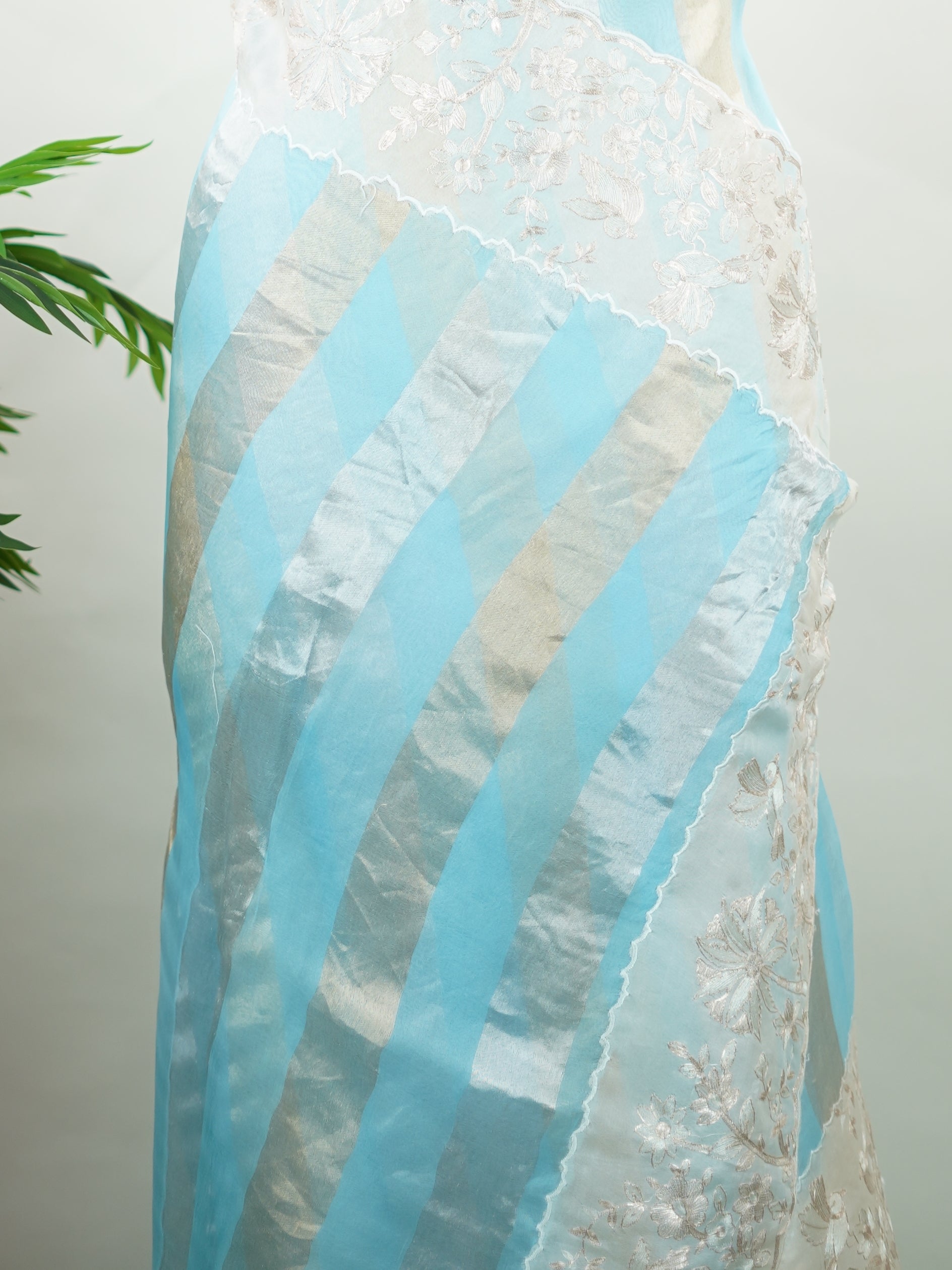 Organza Elegant organza saree in sky blue and white tones featuring intricate Aari Peeta work on the pallu. The sheer, lightweight fabric drapes beautifully, giving a fresh and graceful silhouette.br data-start=191 data-end=194Delicate handcrafted embroidery adds depth, charm, and timeless sophistication.br data-start=273 data-end=276Perfect for weddings, festive celebrations, and special occasions with serene ethnic elegance. Rhea - Organza Saree | Embroidered - Manoranjitham Weaves - Handloom Store