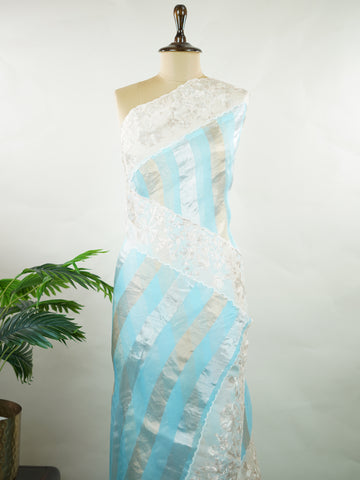 Organza Elegant organza saree in sky blue and white tones featuring intricate Aari Peeta work on the pallu. The sheer, lightweight fabric drapes beautifully, giving a fresh and graceful silhouette.br data-start=191 data-end=194Delicate handcrafted embroidery adds depth, charm, and timeless sophistication.br data-start=273 data-end=276Perfect for weddings, festive celebrations, and special occasions with serene ethnic elegance. Rhea - Organza Saree | Embroidered - Manoranjitham Weaves - Handloom Store
