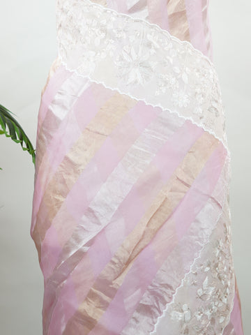 Organza Elegant organza saree in pink and white tones featuring delicate Aari Peeta work on the pallu. The sheer, lightweight fabric drapes softly, giving a graceful and feminine silhouette.br data-start=184 data-end=187Intricate handcrafted embroidery enhances its charm with rich detail and subtle elegance.br data-start=276 data-end=279Perfect for weddings, festive celebrations, and special occasions with timeless ethnic beauty. Aira - Organza Saree | Embroidered - Manoranjitham Weaves - Handloom Store