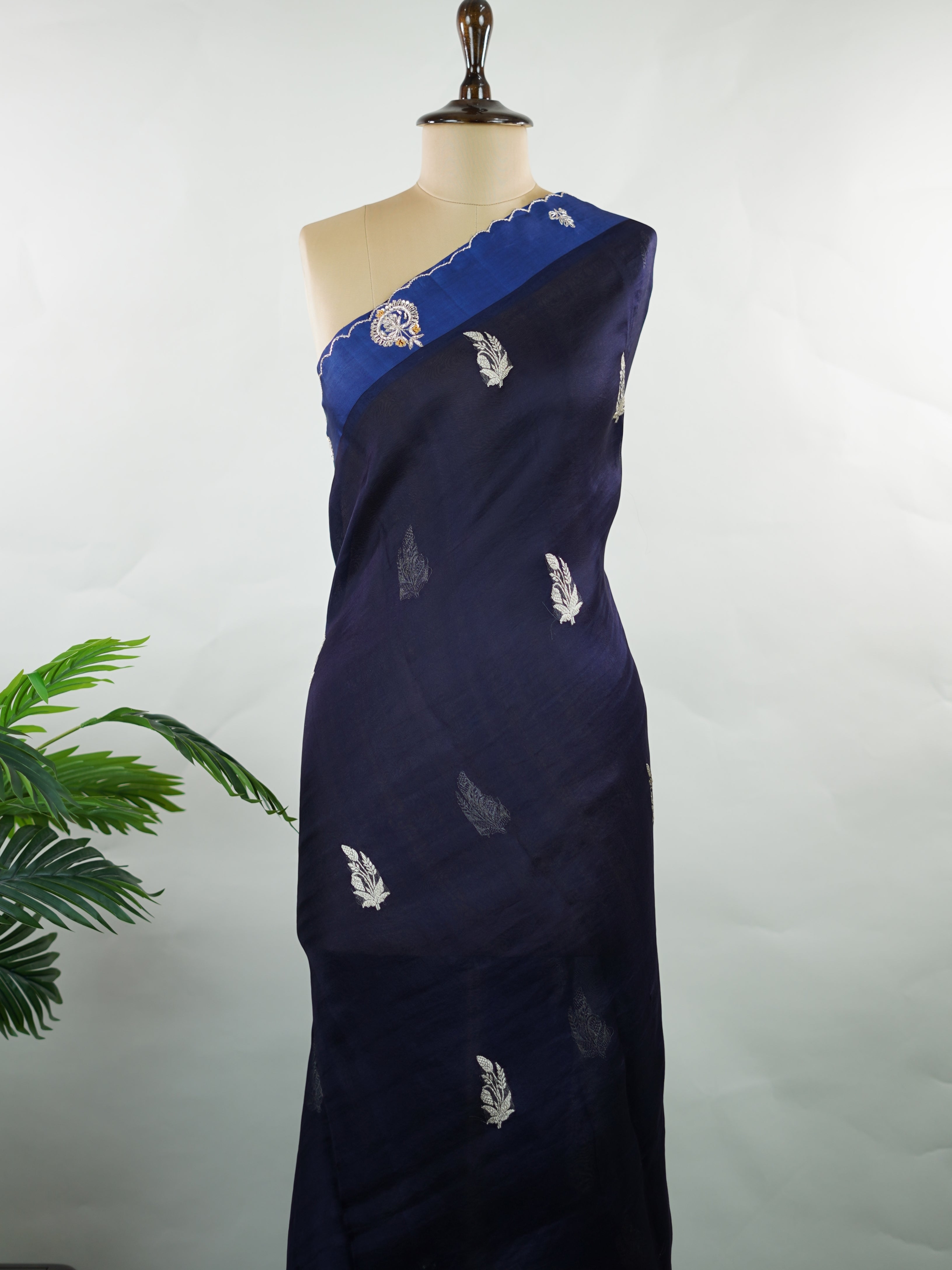 Organza Stunning dark blue organza saree adorned with elegant embroidery for a regal look.br data-start=82 data-end=85The sheer, lightweight fabric offers a graceful drape and effortless sophistication.br data-start=169 data-end=172Intricate embroidered work adds depth, texture, and timeless charm.br data-start=239 data-end=242Perfect for weddings, festive gatherings, and evening celebrations. Kiara - Organza Saree | Embroidered - Manoranjitham Weaves - Handloom Store