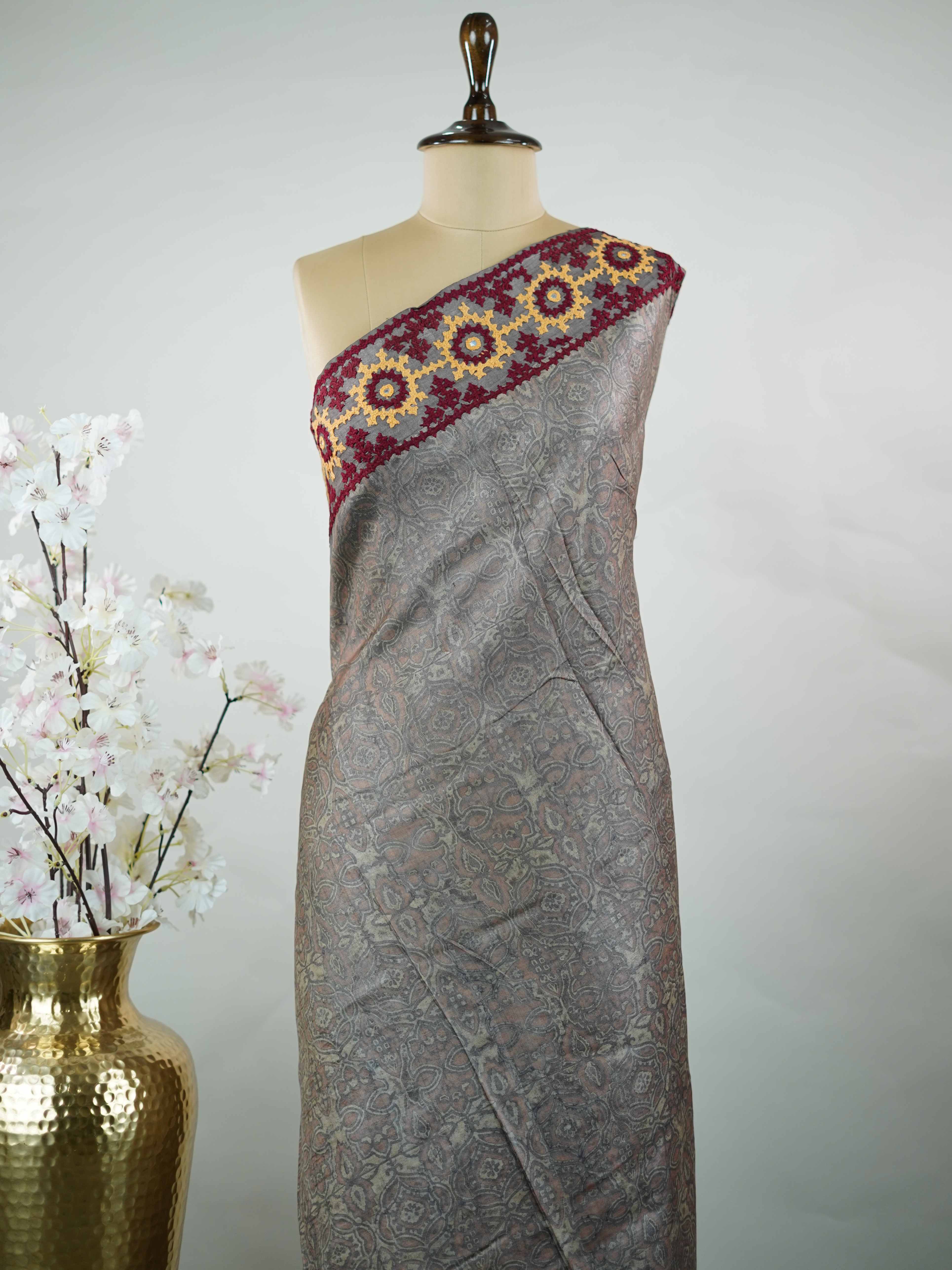 Tussar A refined Tussar saree in a rich grey base, highlighted with striking red accents for a bold contrast.br
Adorned with intricate Kutch embroidery, it celebrates vibrant craftsmanship with a timeless appeal. Priya - Grey Tussar Silk Saree | Kutch Work - Manoranjitham Weaves - Handloom Store