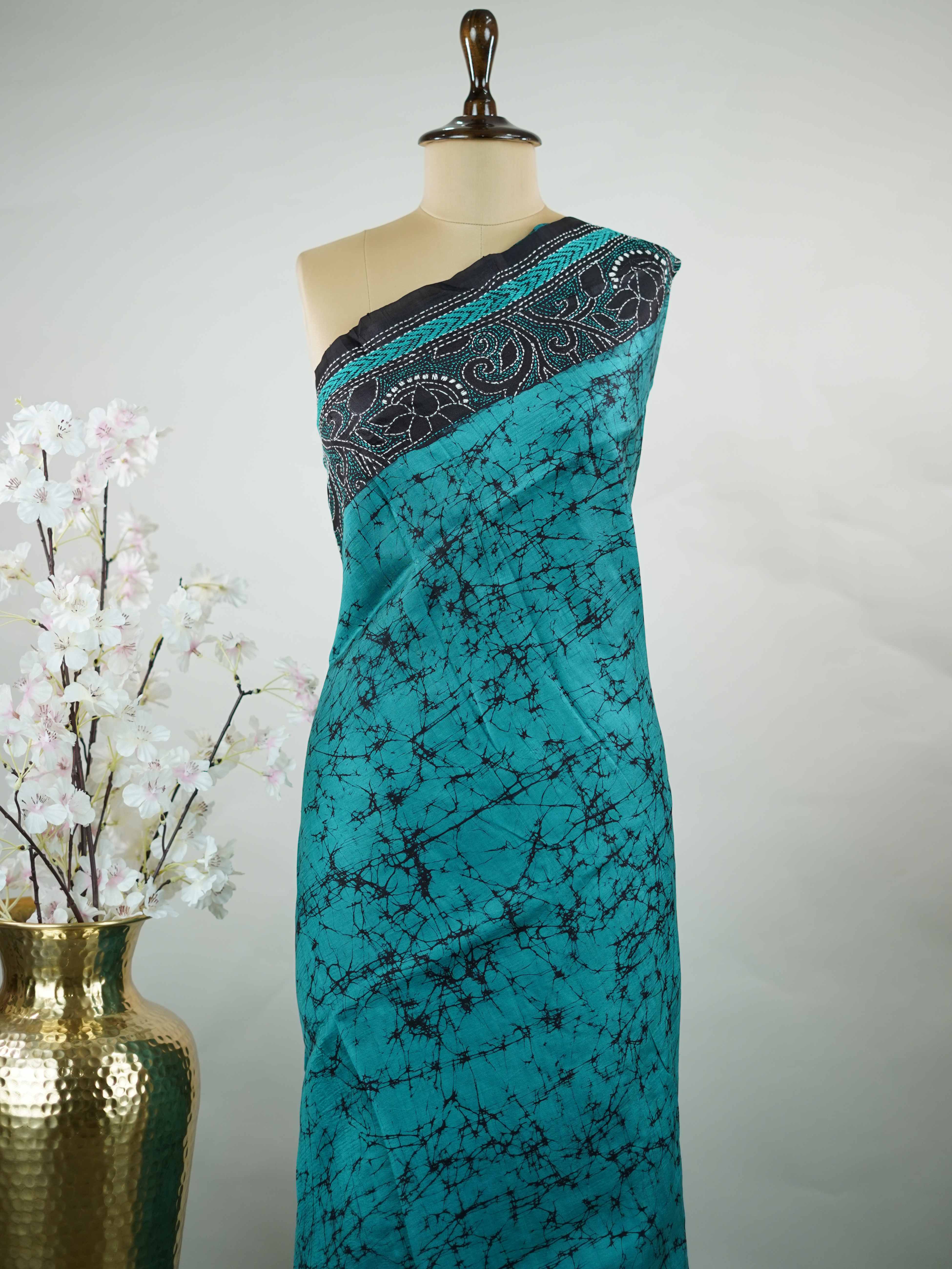 Tussar A striking blue soft silk saree paired with deep black accents, creating a bold and elegant contrast.br
Detailed with fine Kantha stitching and modern digital prints, it beautifully blends heritage craft with contemporary style. Varuni - Tussar Silk Saree | Kantha Embroidery - Manoranjitham Weaves - Handloom Store