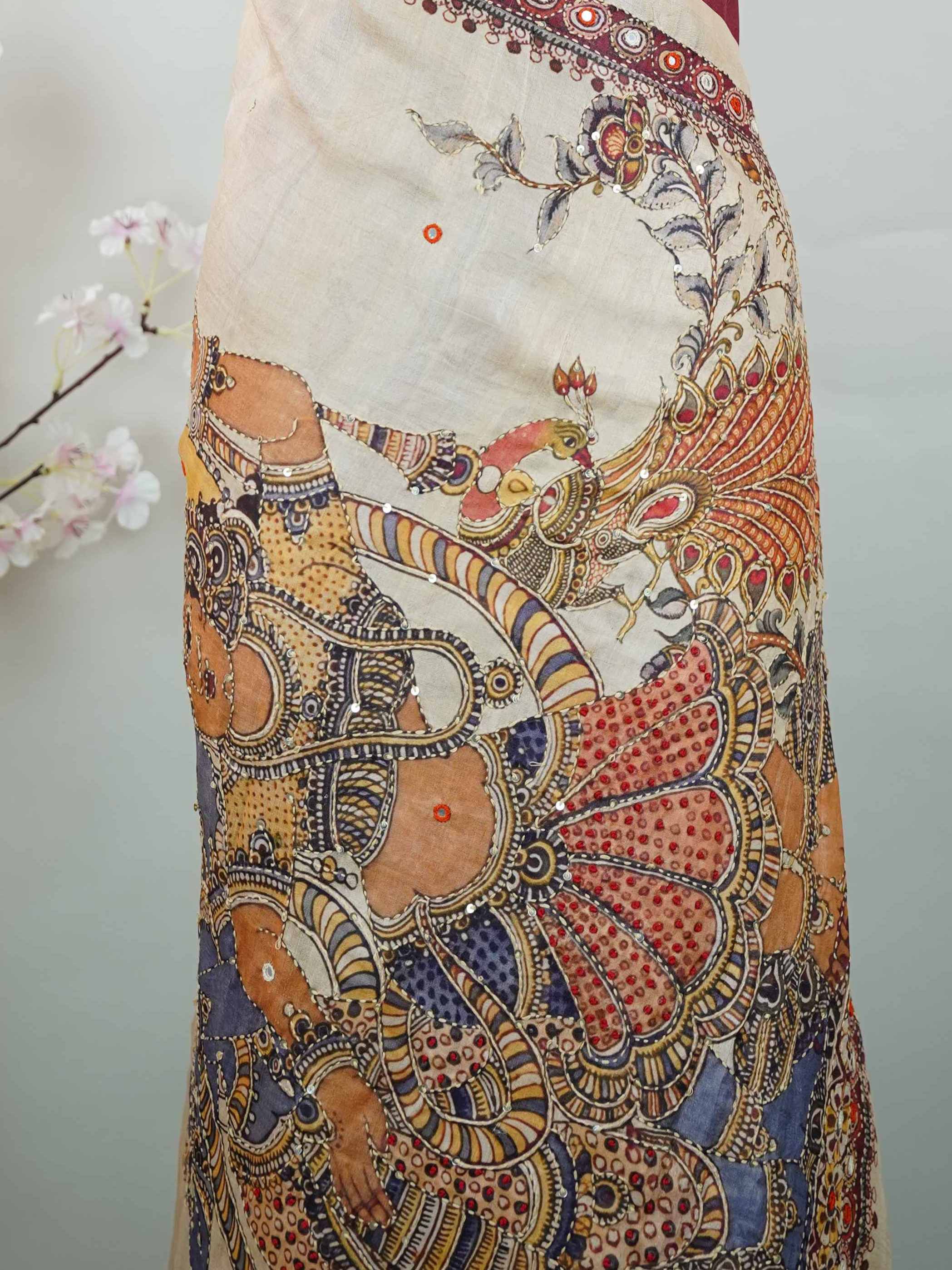 Tussar Maroon Tussar silk body paired with a serene cream pallu and blouse, highlighted by intricate Radha Krishna embroidery.br
A graceful harmony of devotion and contrast, blending rich tones with timeless artistry. Kishori - Maroon Tussar Silk Saree | Radha Krishna Embroidery - Manoranjitham Weaves - Handloom Store