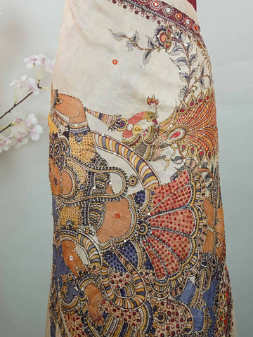 Tussar Maroon Tussar silk body paired with a serene cream pallu and blouse, highlighted by intricate Radha Krishna embroidery.br
A graceful harmony of devotion and contrast, blending rich tones with timeless artistry. Kishori - Maroon Tussar Silk Saree | Radha Krishna Embroidery - Manoranjitham Weaves - Handloom Store