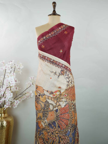 Tussar Maroon Tussar silk body paired with a serene cream pallu and blouse, highlighted by intricate Radha Krishna embroidery.br
A graceful harmony of devotion and contrast, blending rich tones with timeless artistry. Kishori - Maroon Tussar Silk Saree | Radha Krishna Embroidery - Manoranjitham Weaves - Handloom Store