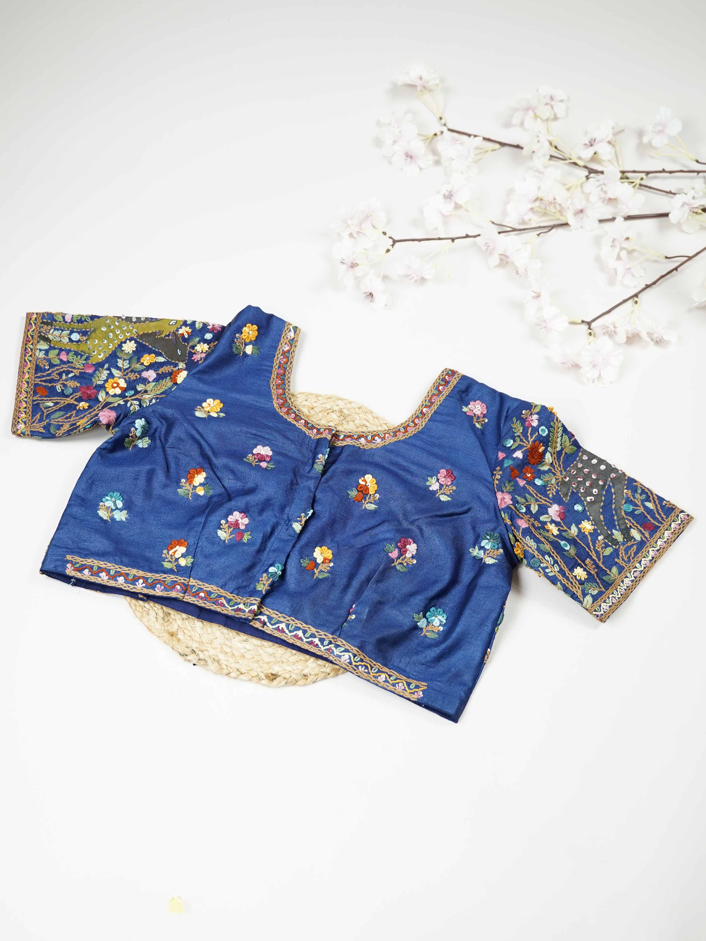 Tussar This elegant blue Tussar blouse features finely stitched hand embroidery work on both front and back. The intricate designs highlight rich craftsmanship with graceful and artistic detailing. The deep blue shade enhances the embroidery, giving it a bold and elegant appeal.br data-start=276 data-end=279Perfect for ethnic wear, it creates a stylish, refined, and beautifully handcrafted traditional look. Tanirika - Tussar Silk Saree | Hand Embroidered - Manoranjitham Weaves - Handloom Store