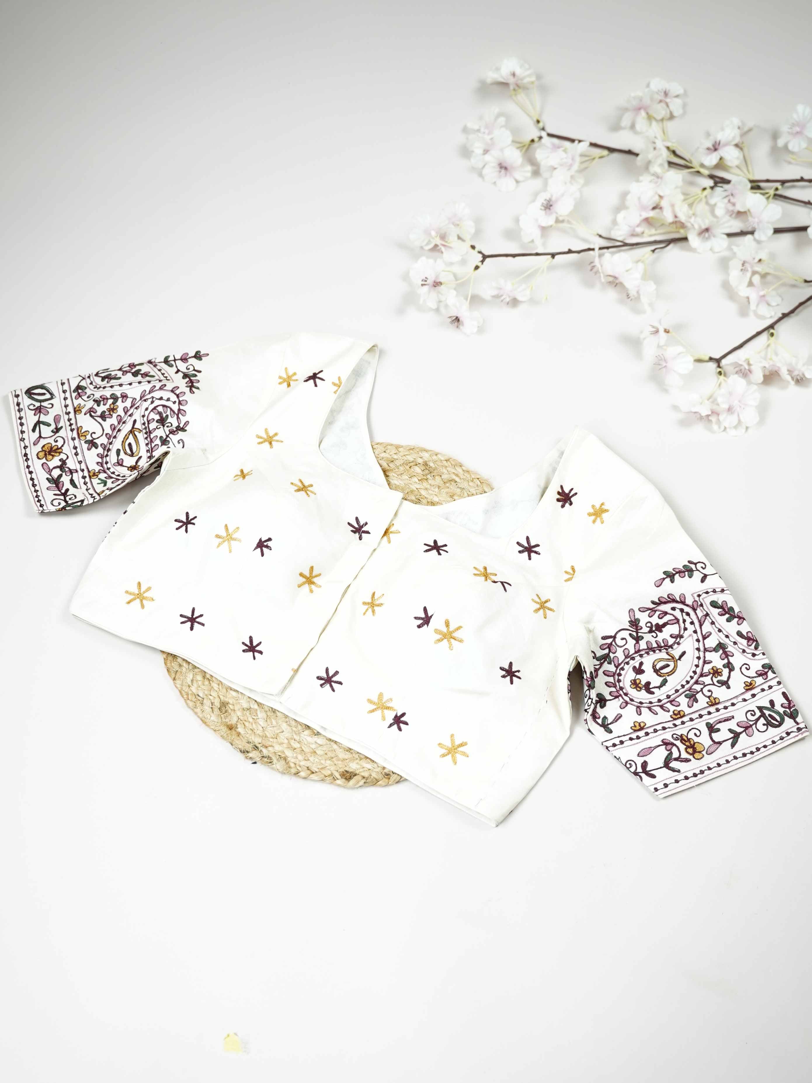 Tussar This elegant white Tussar blouse features finely stitched hand embroidery work.br data-start=79 data-end=82The delicate embroidery adds subtle texture and graceful handcrafted detailing.br data-start=161 data-end=164The classic white shade enhances the intricate work with a pure and timeless appeal.br data-start=248 data-end=251Perfect for ethnic wear, it creates a simple, elegant, and beautifully traditional look. Aadhira - Tussar Silk Saree | Hand Embroidered - Manoranjitham Weaves - Handloom Store