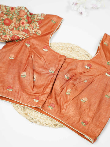 Tussar This elegant orange Tussar blouse features finely stitched hand embroidery with delicate floral designs. The intricate flower patterns add a rich and graceful handcrafted charm.br data-start=179 data-end=182The vibrant orange shade enhances the embroidery, giving it a bright and festive appeal.br data-start=270 data-end=273Perfect for ethnic wear, it creates a stylish and beautifully detailed traditional look. Sutrika - Tussar Silk Saree | Hand Embroidered - Manoranjitham Weaves - Handloom Store