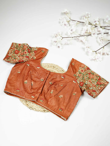 Tussar This elegant orange Tussar blouse features finely stitched hand embroidery with delicate floral designs. The intricate flower patterns add a rich and graceful handcrafted charm.br data-start=179 data-end=182The vibrant orange shade enhances the embroidery, giving it a bright and festive appeal.br data-start=270 data-end=273Perfect for ethnic wear, it creates a stylish and beautifully detailed traditional look. Sutrika - Tussar Silk Saree | Hand Embroidered - Manoranjitham Weaves - Handloom Store