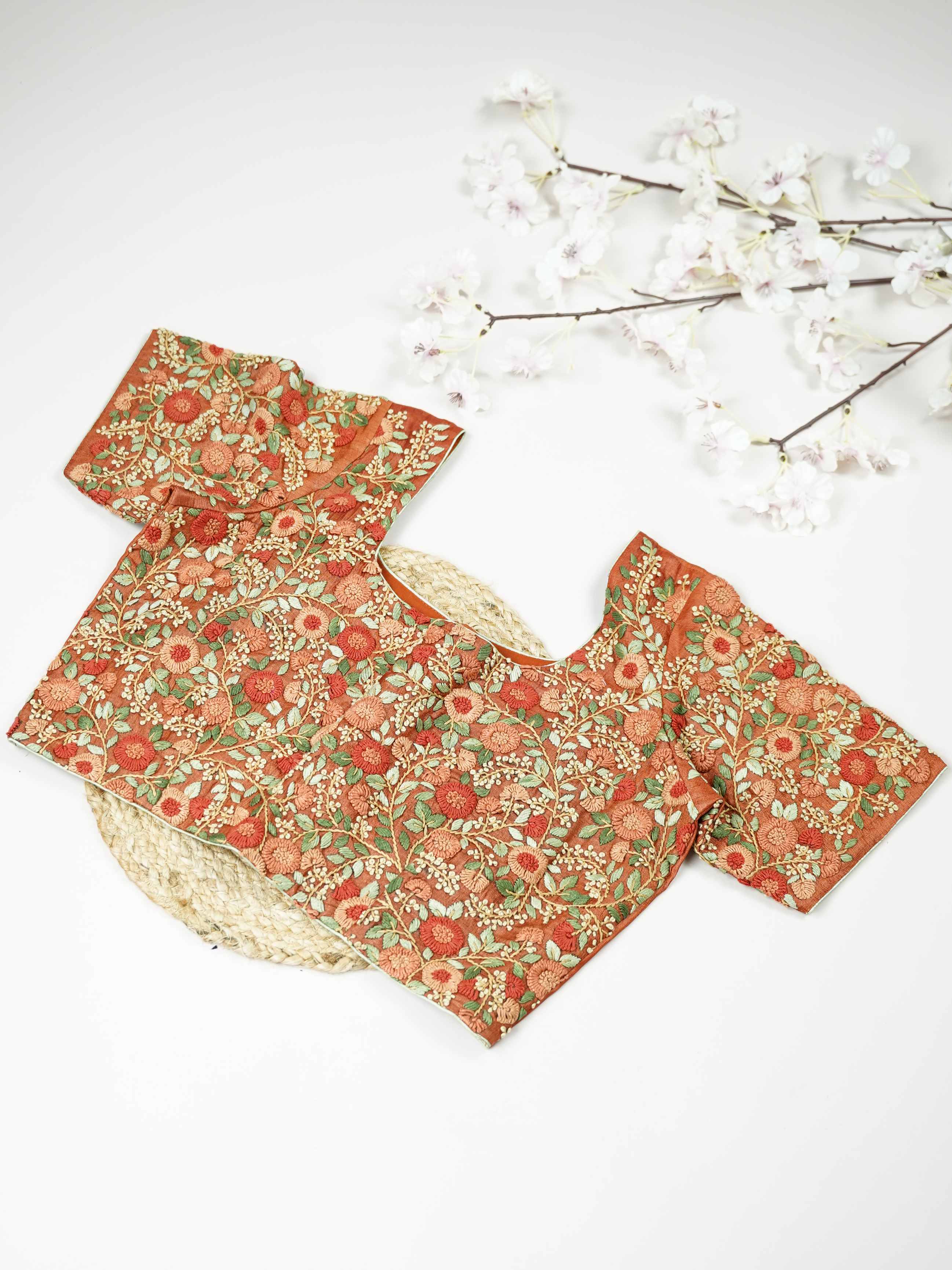 Tussar This elegant orange Tussar blouse features finely stitched hand embroidery with delicate floral designs. The intricate flower patterns add a rich and graceful handcrafted charm.br data-start=179 data-end=182The vibrant orange shade enhances the embroidery, giving it a bright and festive appeal.br data-start=270 data-end=273Perfect for ethnic wear, it creates a stylish and beautifully detailed traditional look. Sutrika - Tussar Silk Saree | Hand Embroidered - Manoranjitham Weaves - Handloom Store
