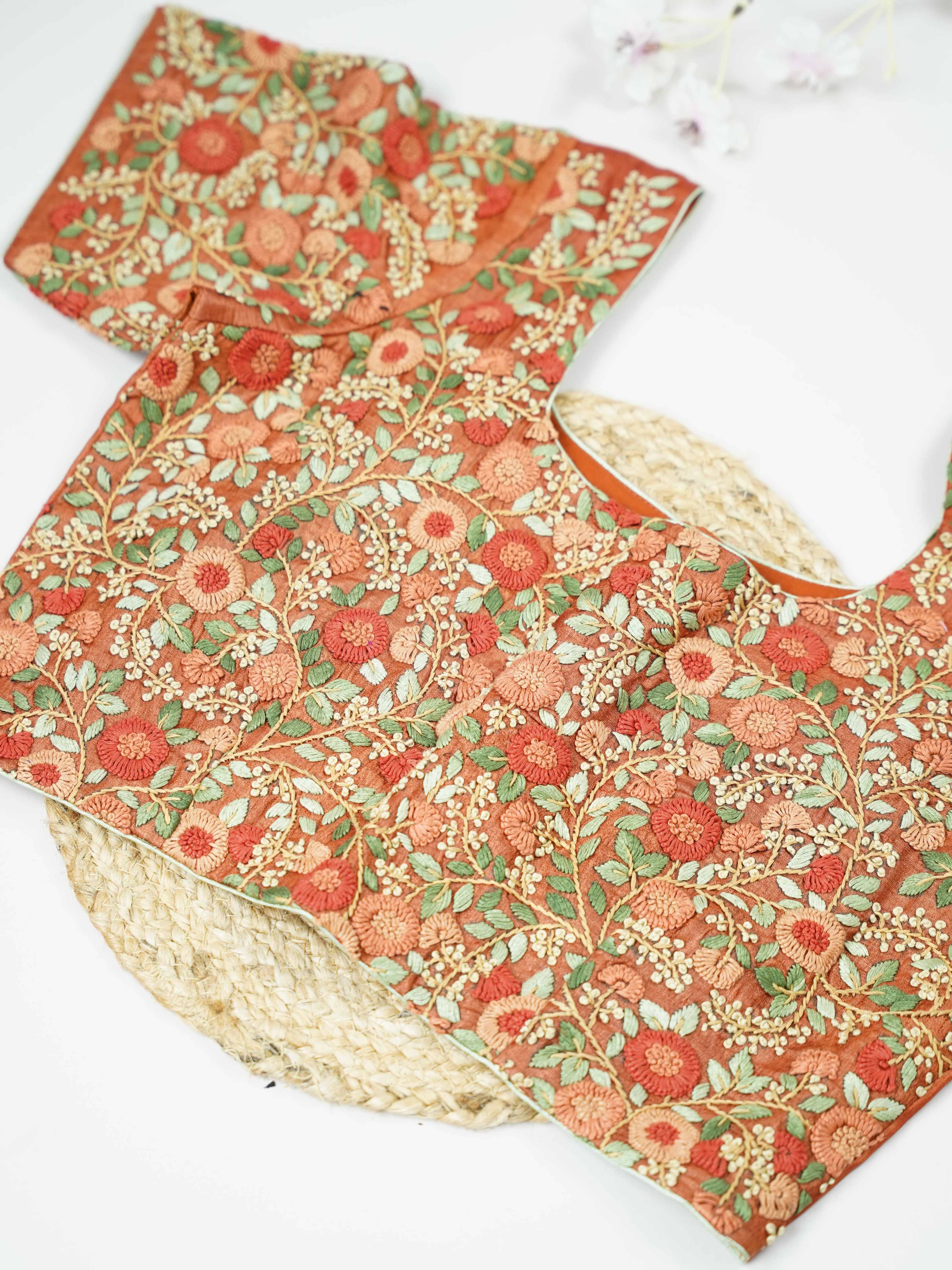 Tussar This elegant orange Tussar blouse features finely stitched hand embroidery with delicate floral designs. The intricate flower patterns add a rich and graceful handcrafted charm.br data-start=179 data-end=182The vibrant orange shade enhances the embroidery, giving it a bright and festive appeal.br data-start=270 data-end=273Perfect for ethnic wear, it creates a stylish and beautifully detailed traditional look. Sutrika - Tussar Silk Saree | Hand Embroidered - Manoranjitham Weaves - Handloom Store